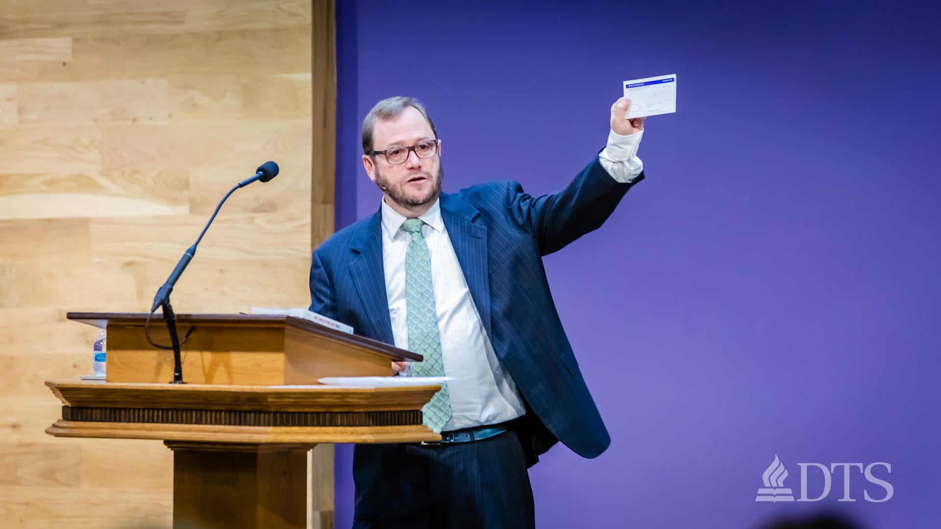 man standing at podium speaking at DTS Chapel