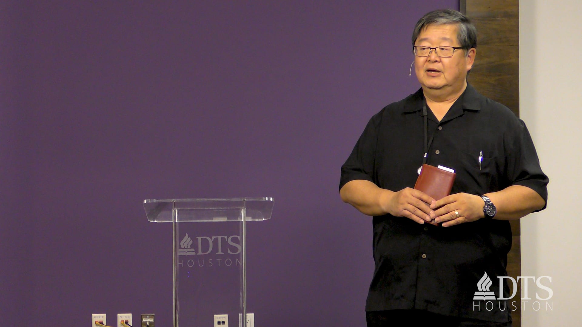 man standing next to podium speaking at DTS Chapel
