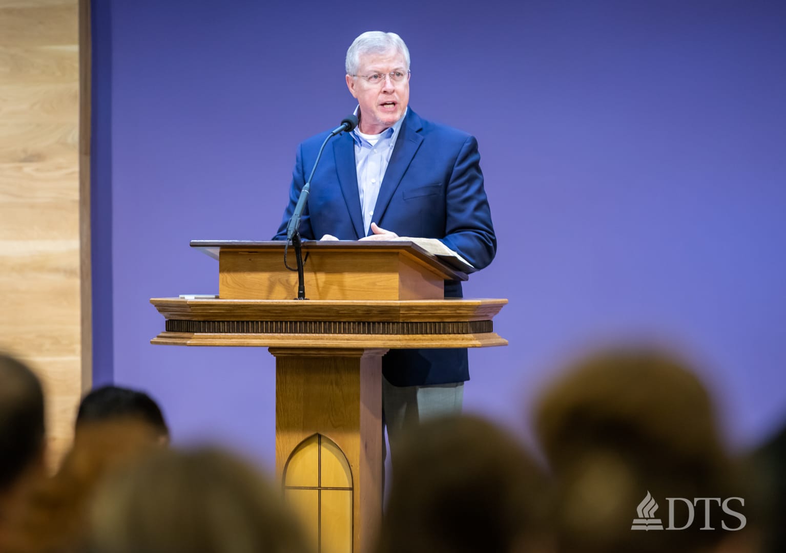 man standing at podium speaking at DTS Chapel