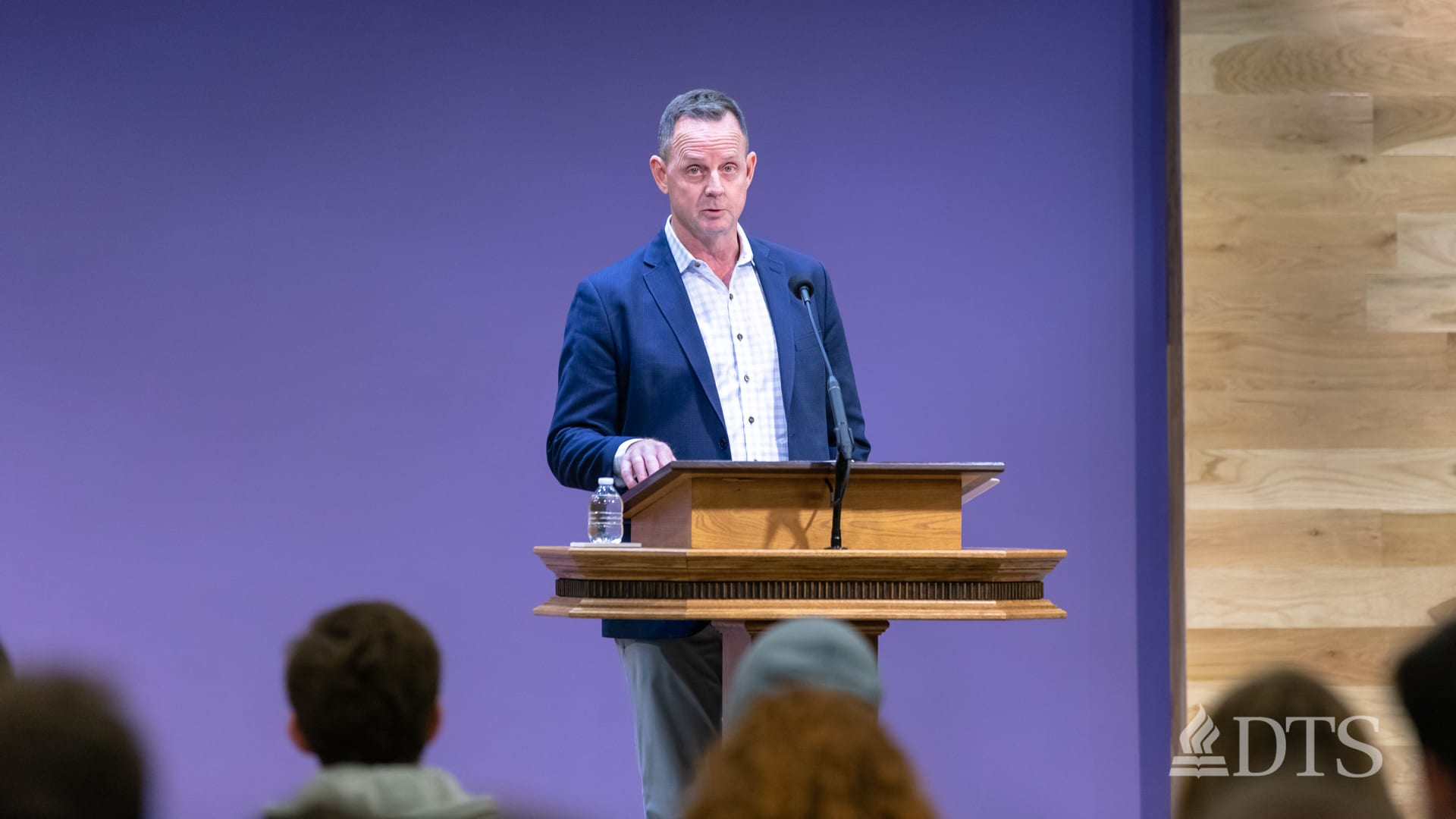 man standing at podium speaking at DTS Chapel
