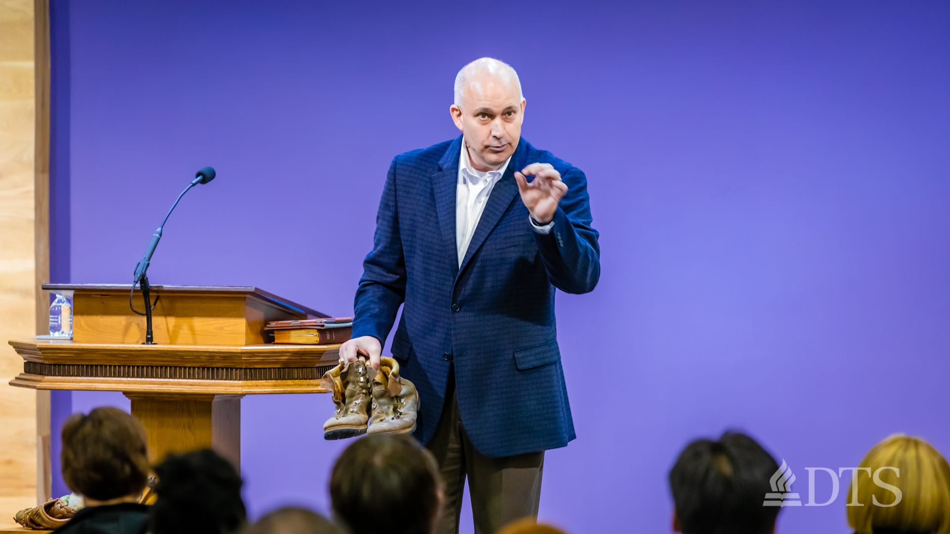 man standing at podium speaking at DTS Chapel