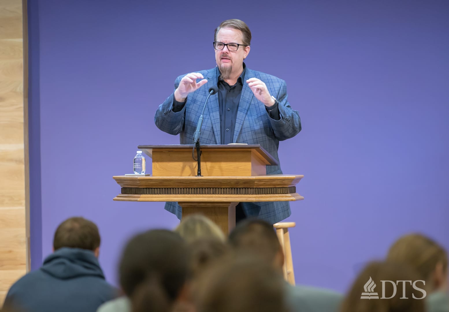 man standing at podium speaking at DTS Chapel