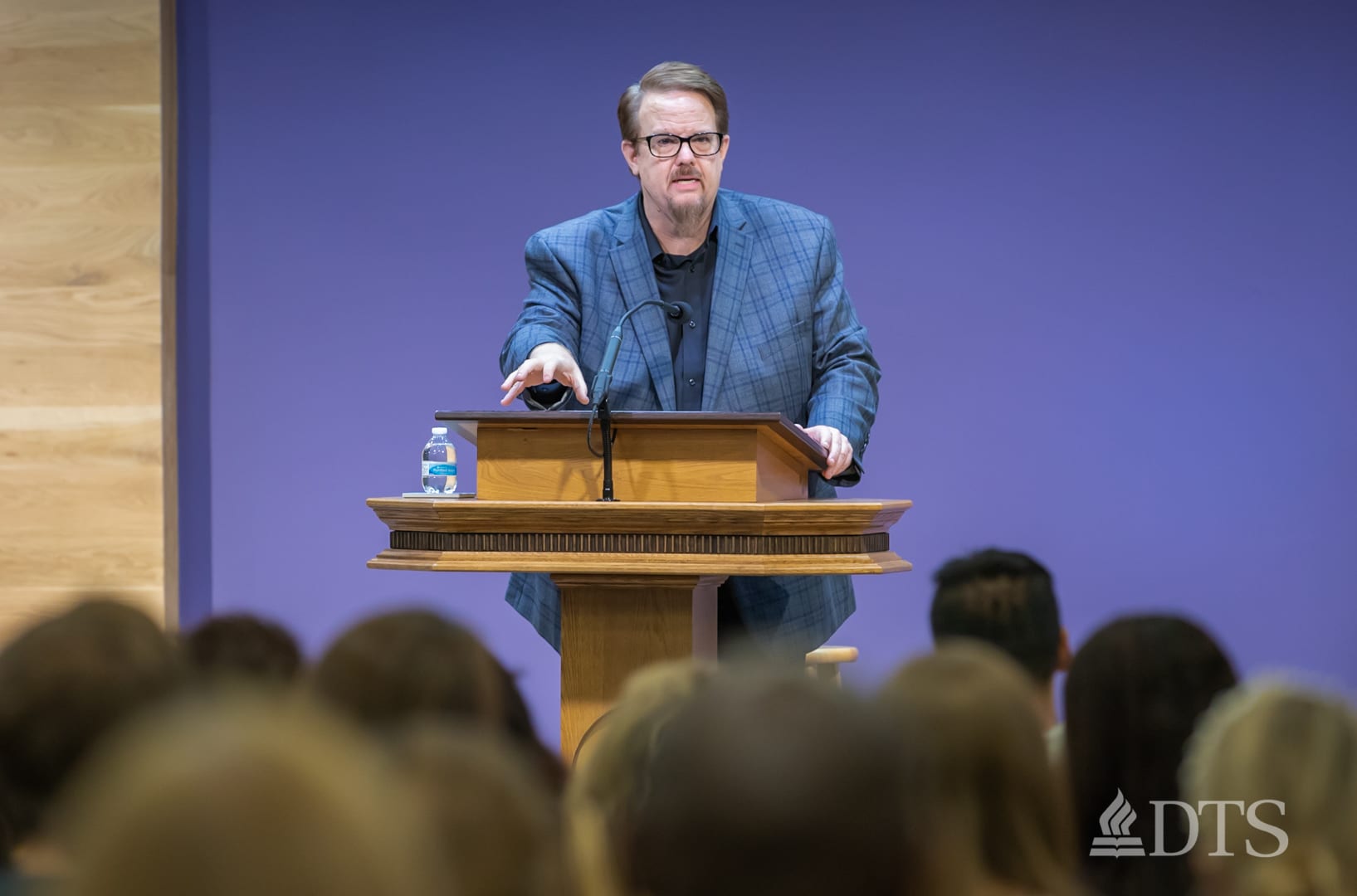 man standing at podium speaking at DTS Chapel