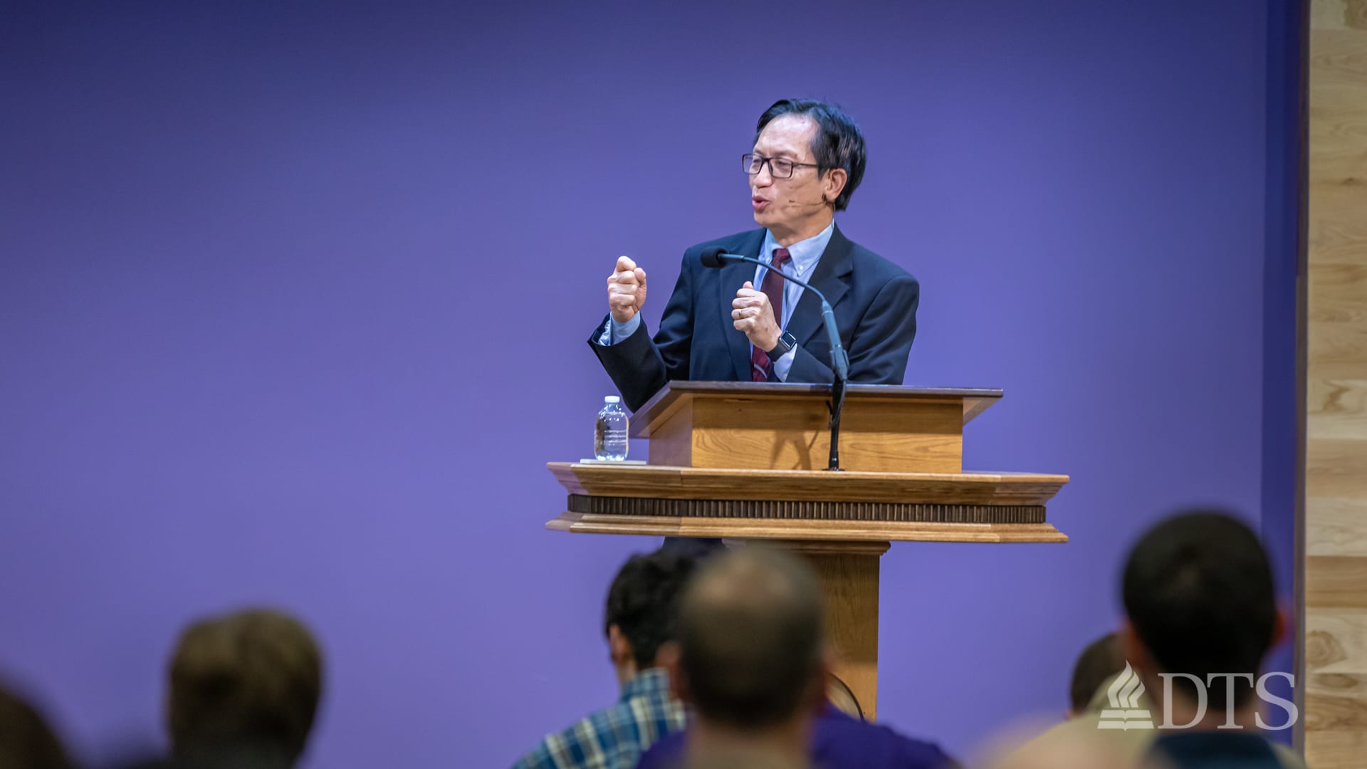 man standing at podium speaking at DTS Chapel