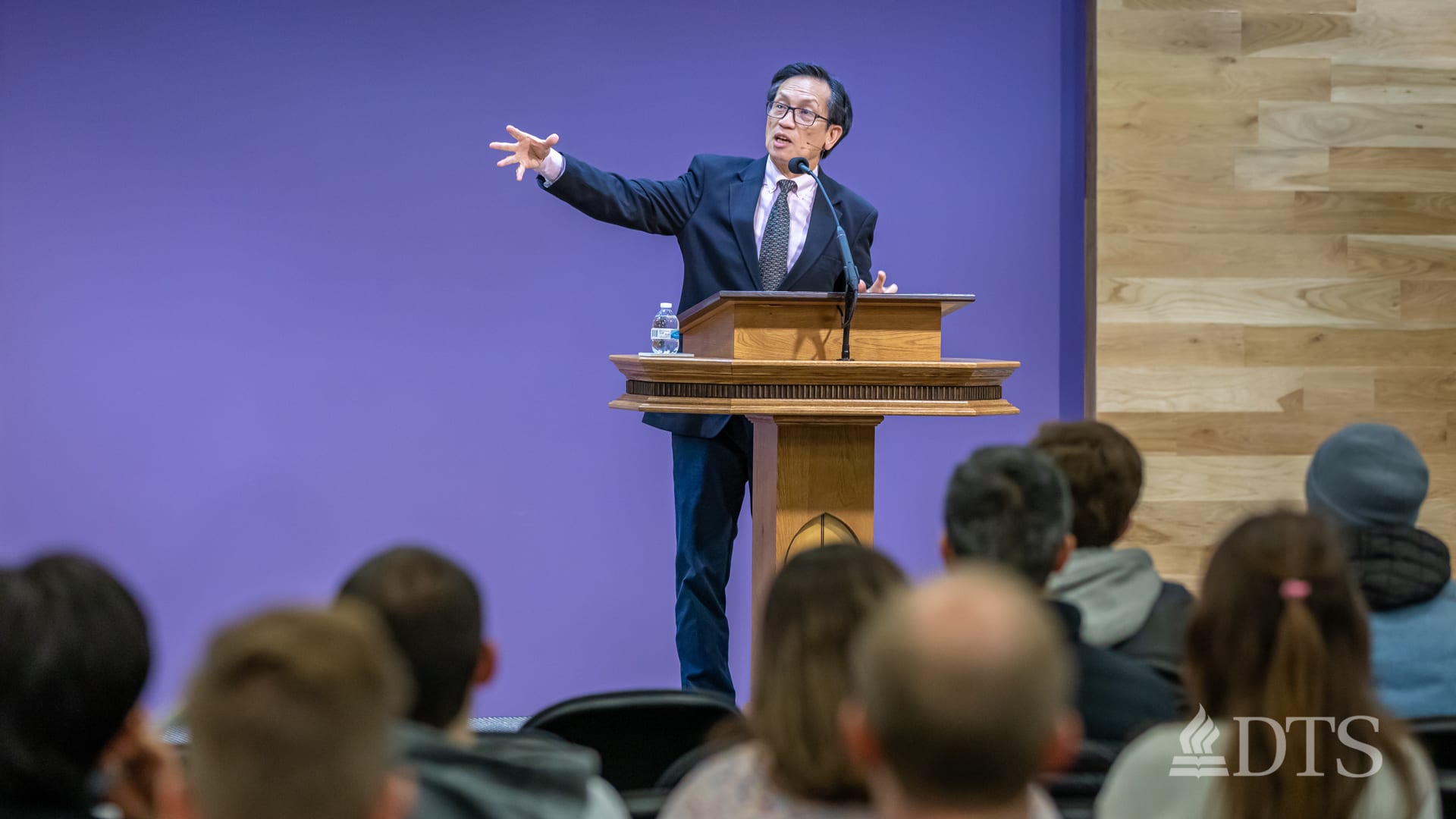 man standing at podium speaking at DTS Chapel