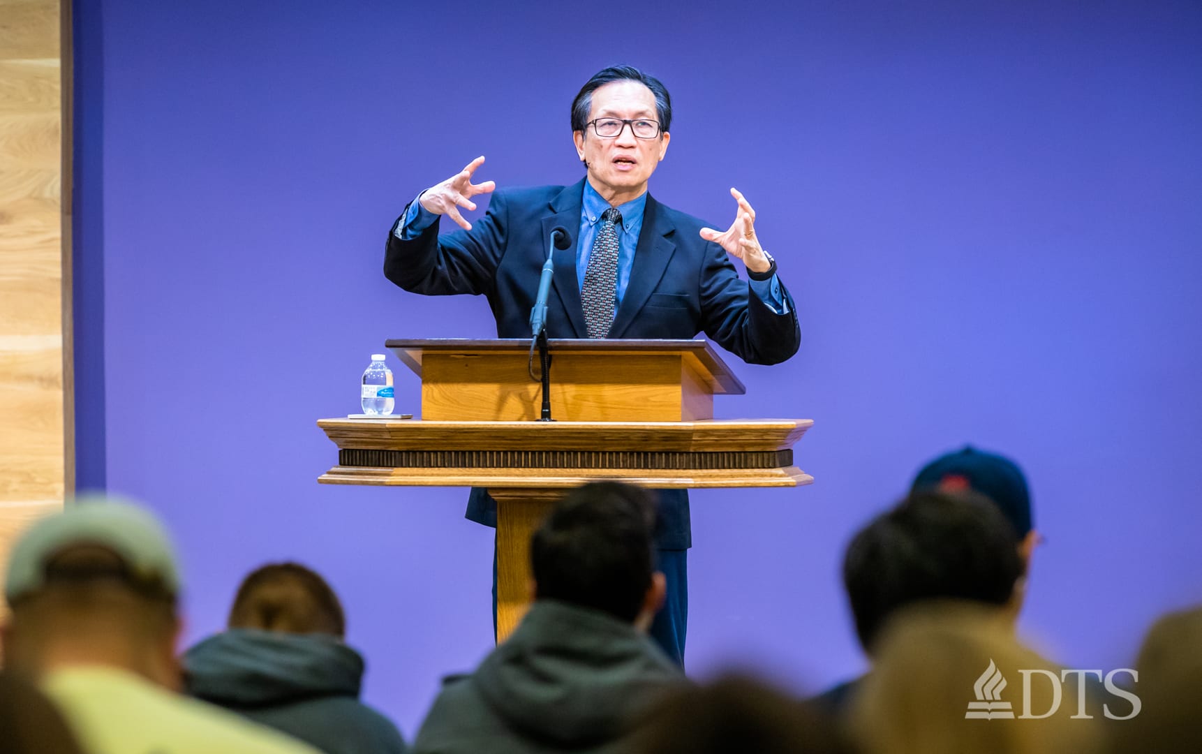 man standing at podium speaking at DTS Chapel
