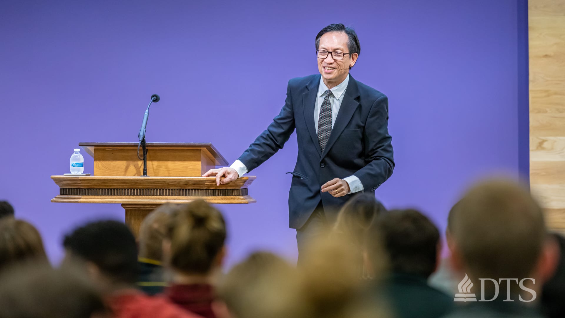 man standing next to podium speaking at DTS Chapel