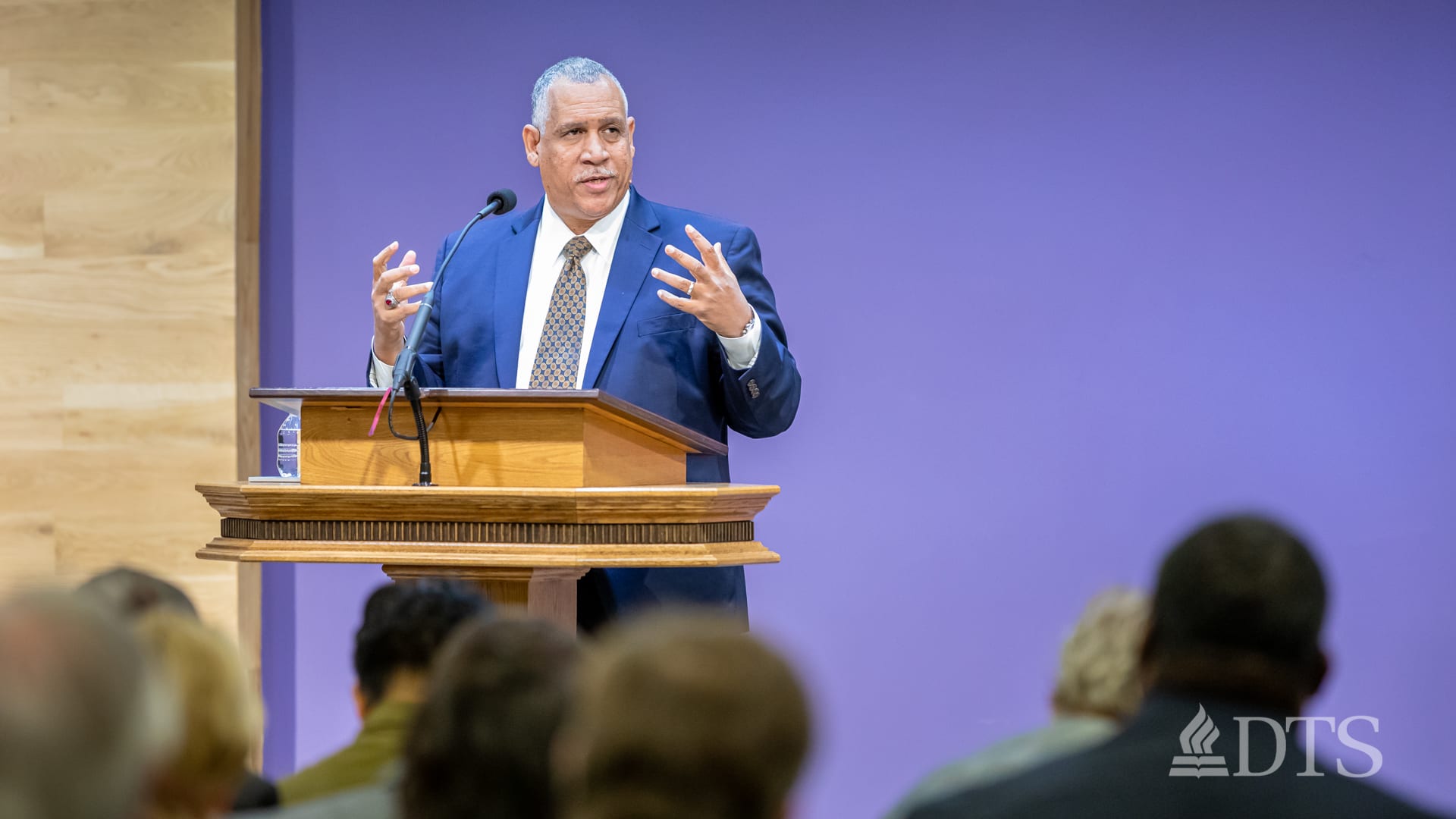 man standing at podium speaking at DTS Chapel