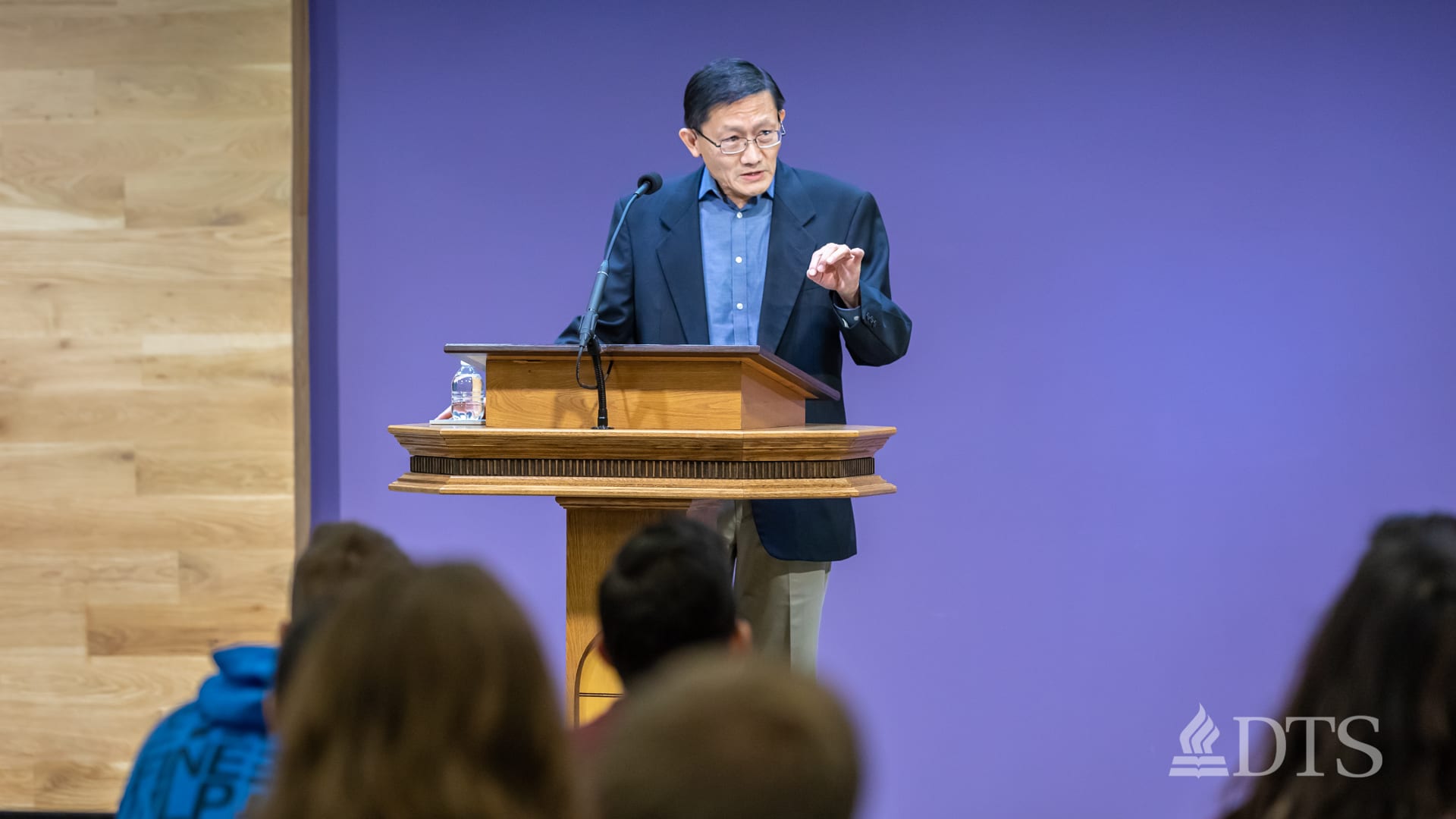 man standing at podium speaking at DTS Chapel
