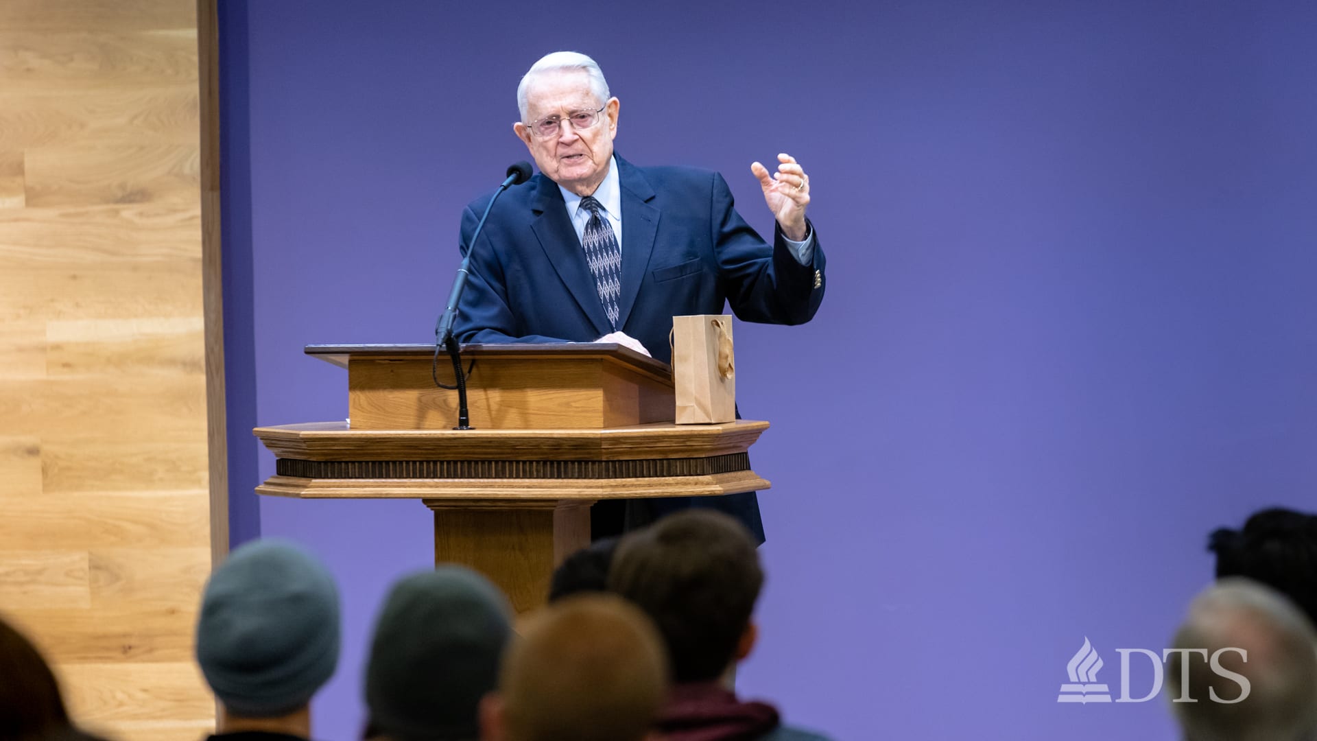 Dr. Chuck Swindoll standing at podium speaking at DTS Chapel