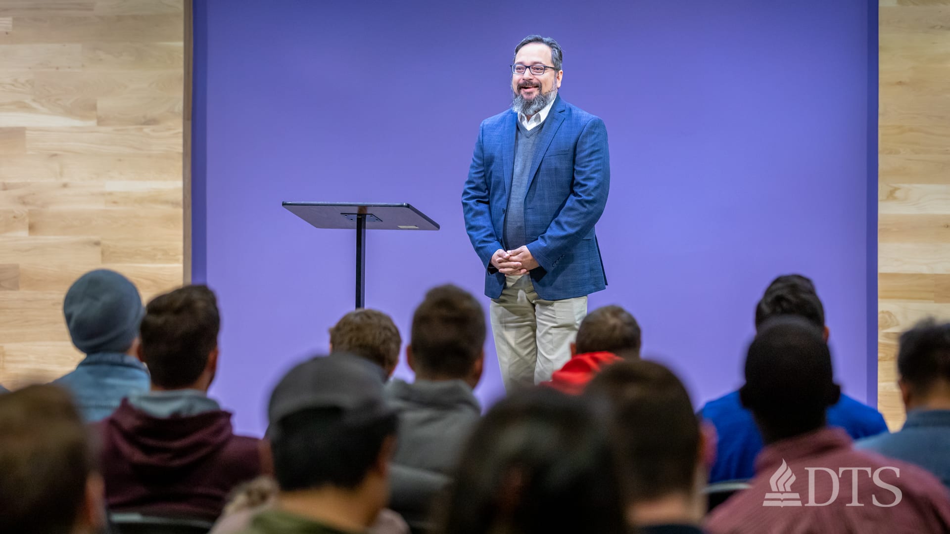 man standing next to podium speaking at DTS Chapel