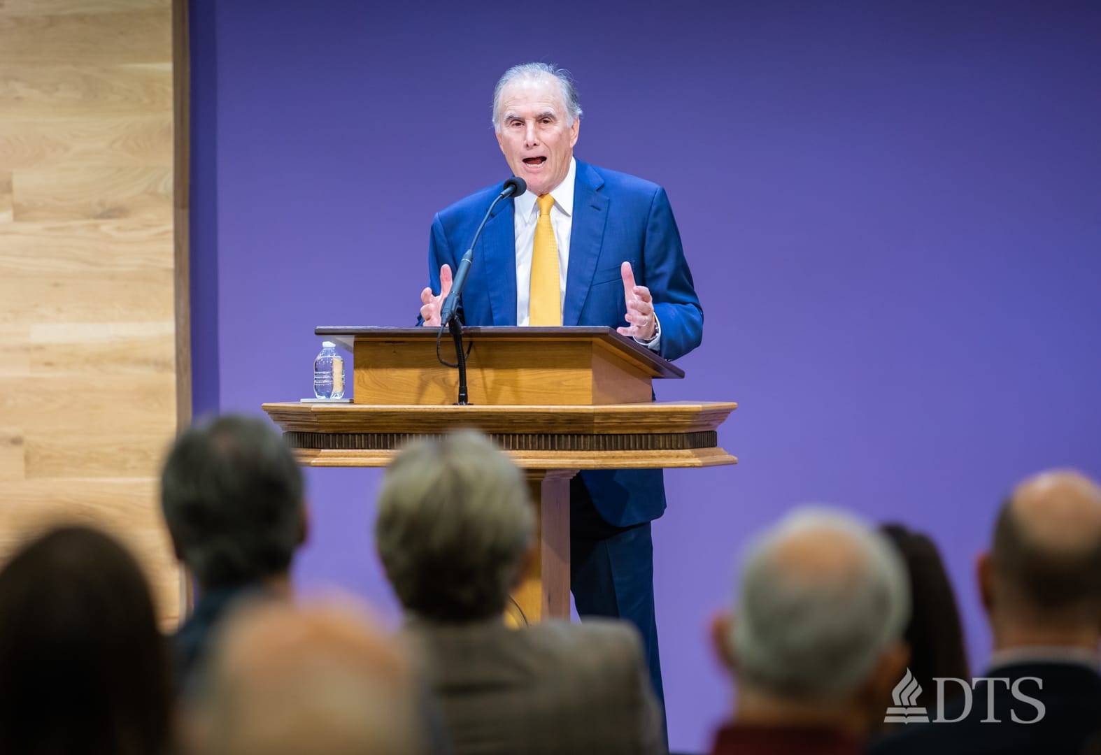 man standing at podium speaking at DTS Chapel