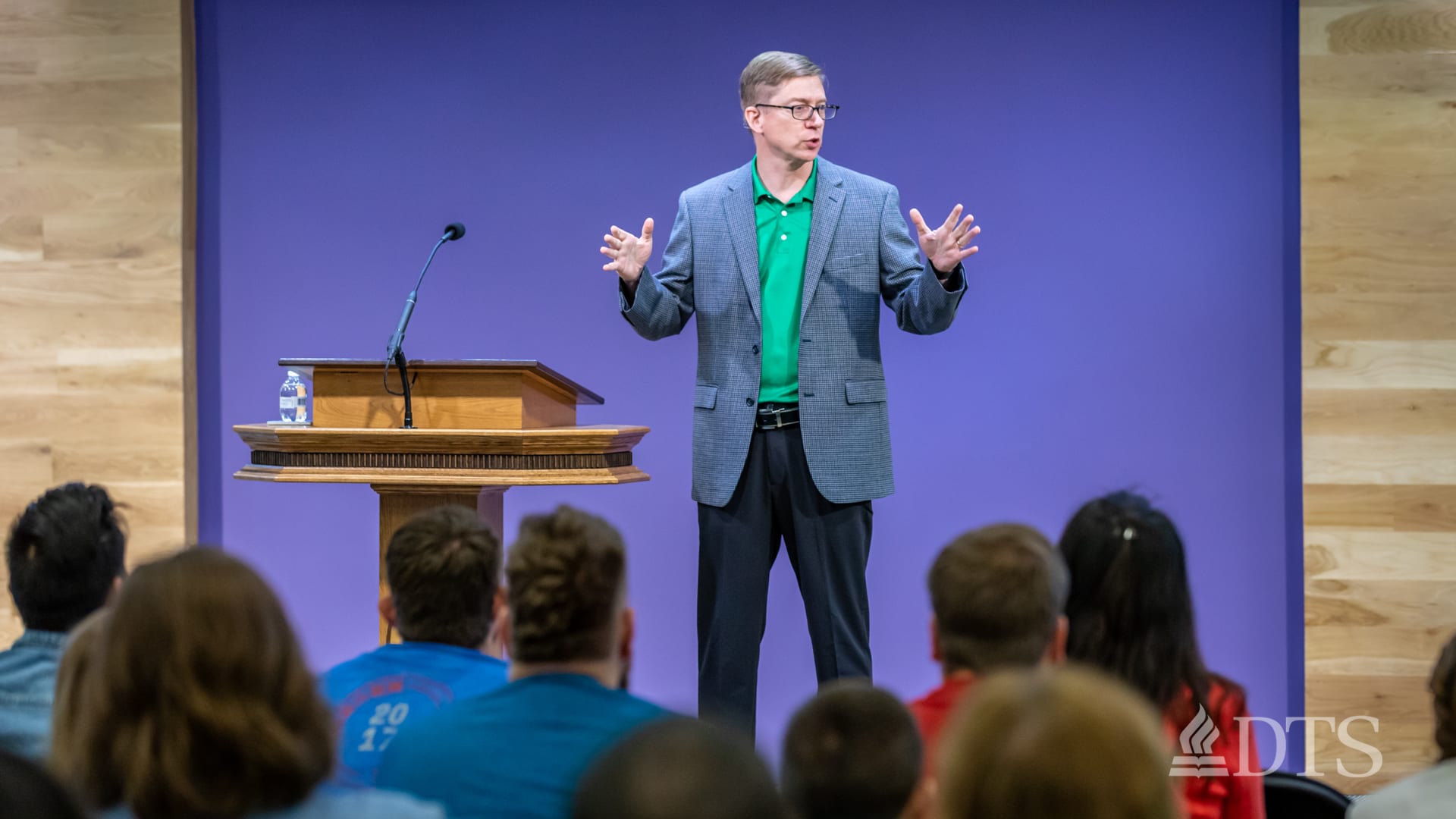 man standing next to podium speaking at DTS Chapel
