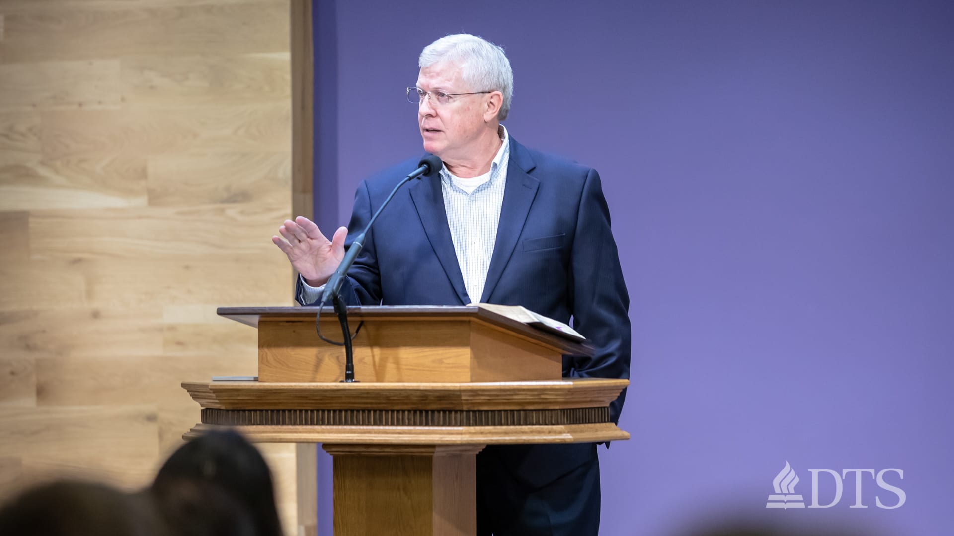 man standing at podium speaking at DTS Chapel
