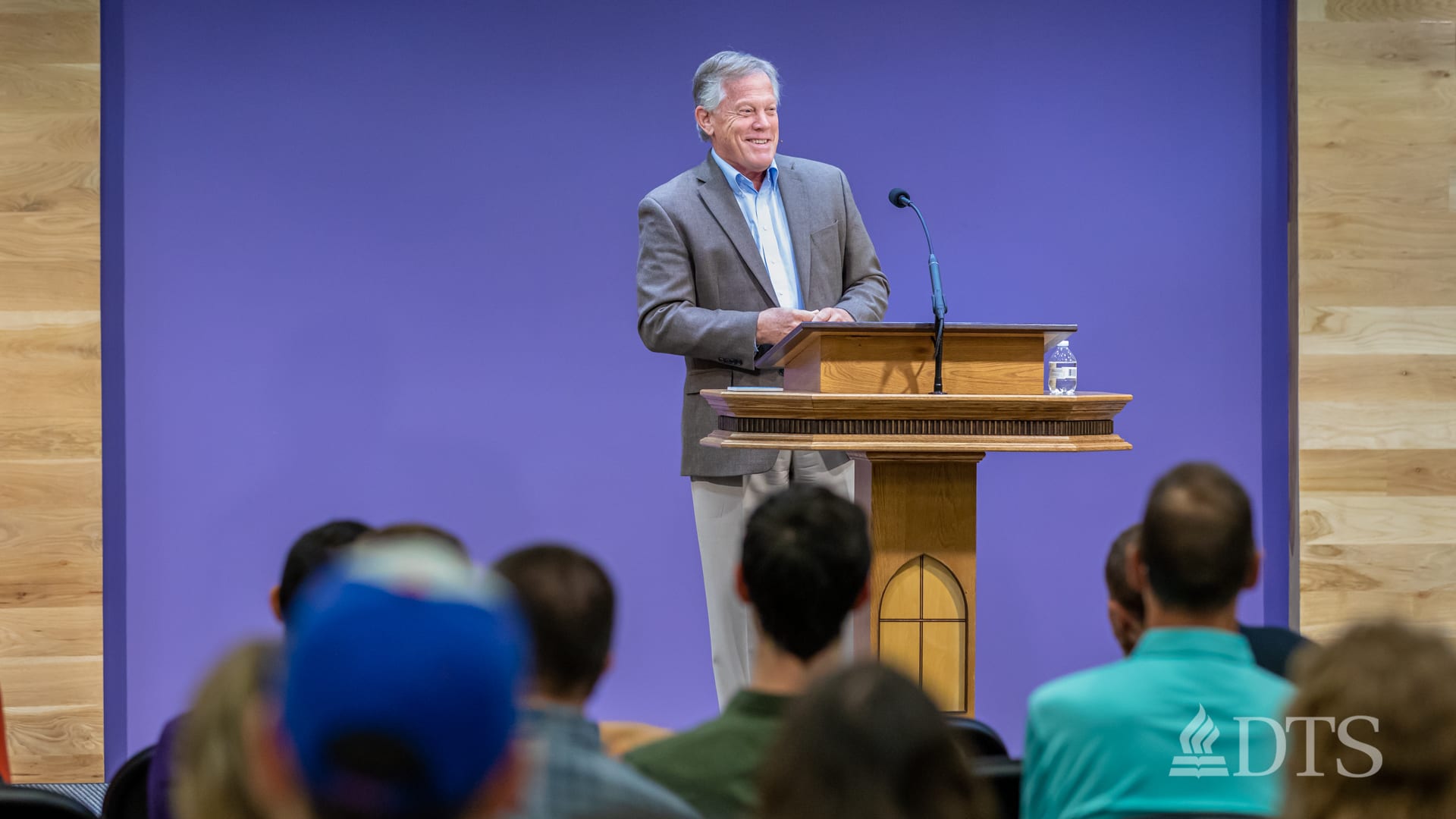 man standing at podium speaking at DTS Chapel