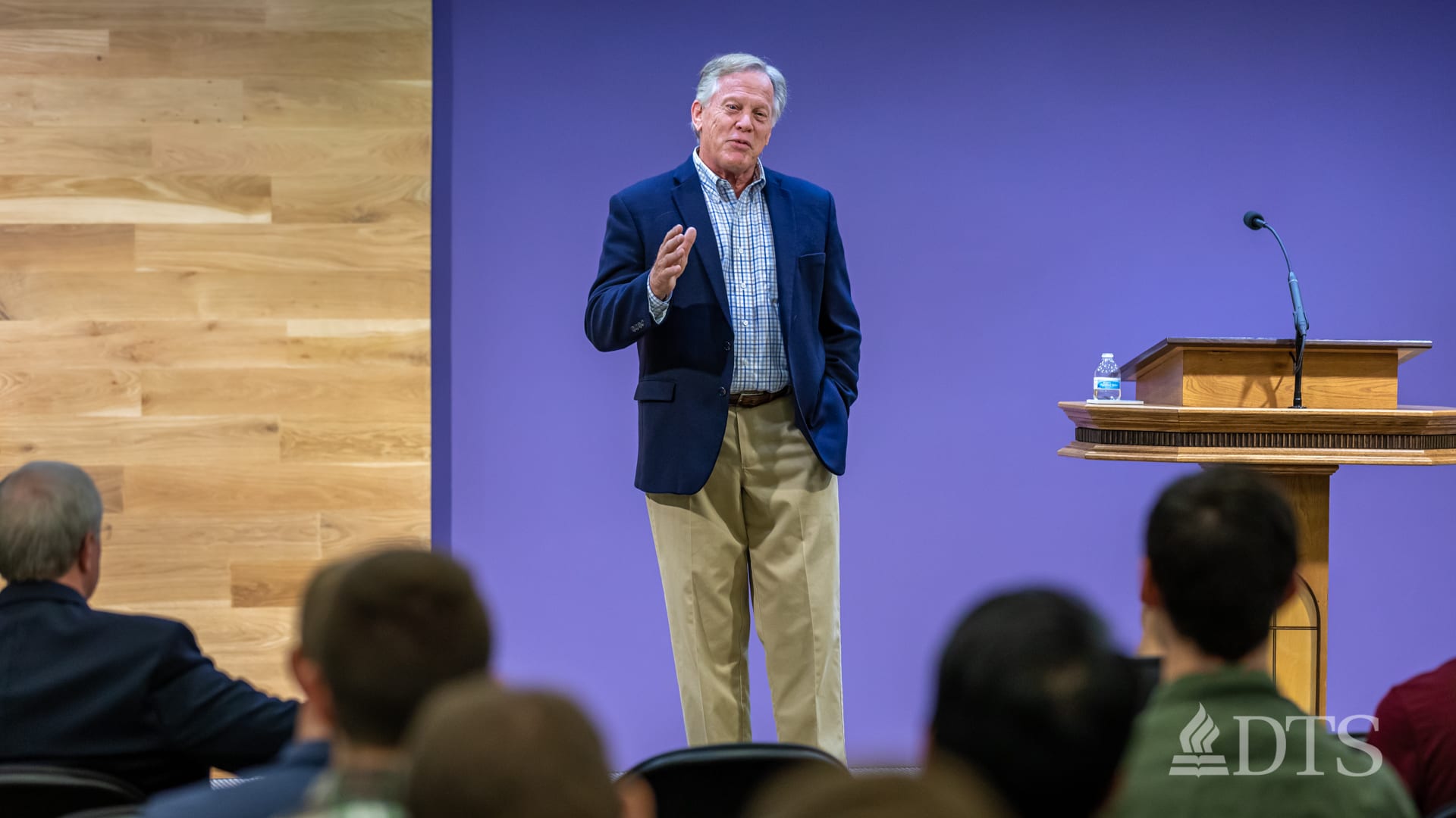 man standing next to podium speaking at DTS Chapel