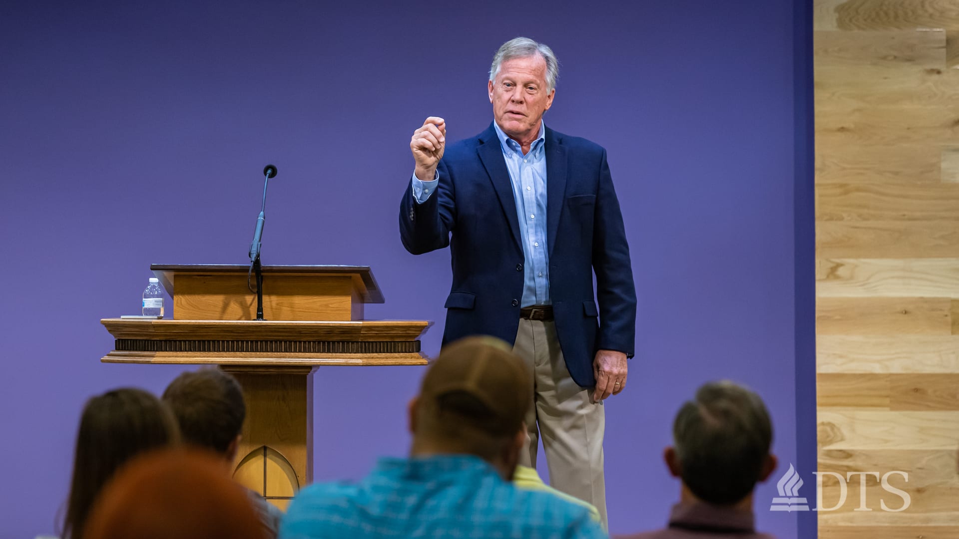 man standing next to podium speaking at DTS Chapel