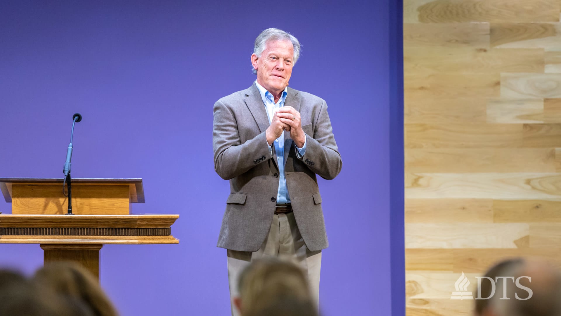 man standing next to podium speaking at DTS Chapel