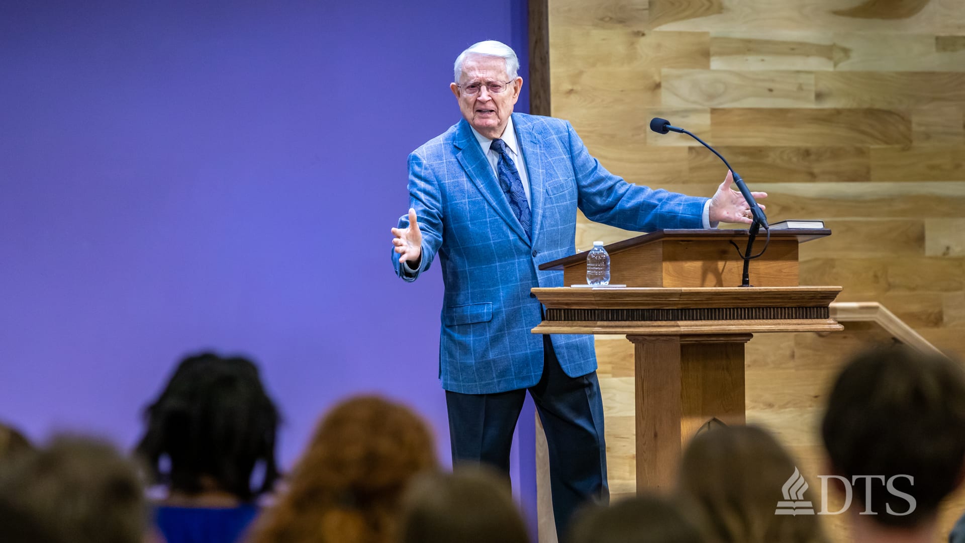 Dr. Chuck Swindoll standing at podium speaking at DTS Chapel