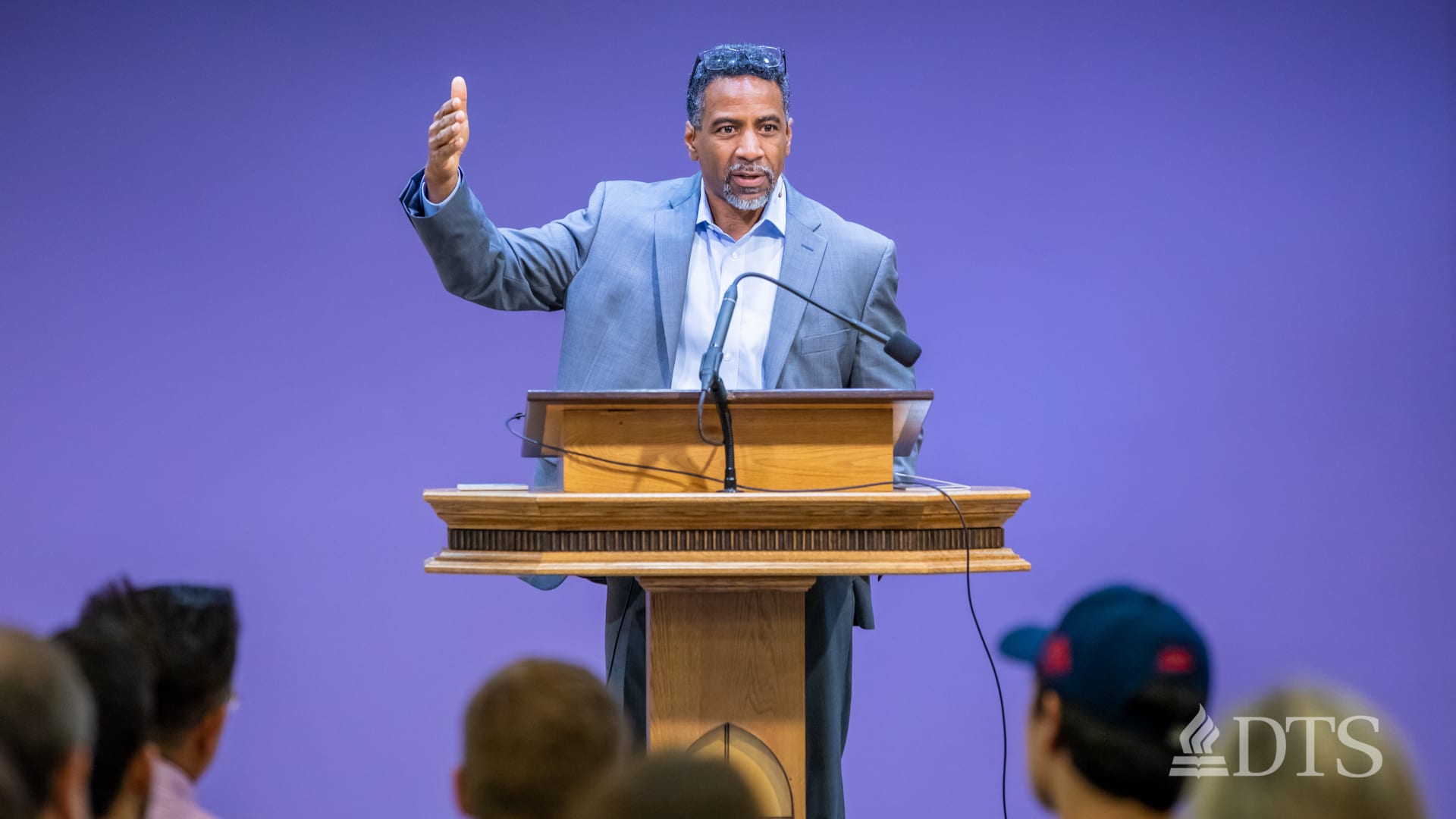 man standing at podium speaking at DTS Chapel