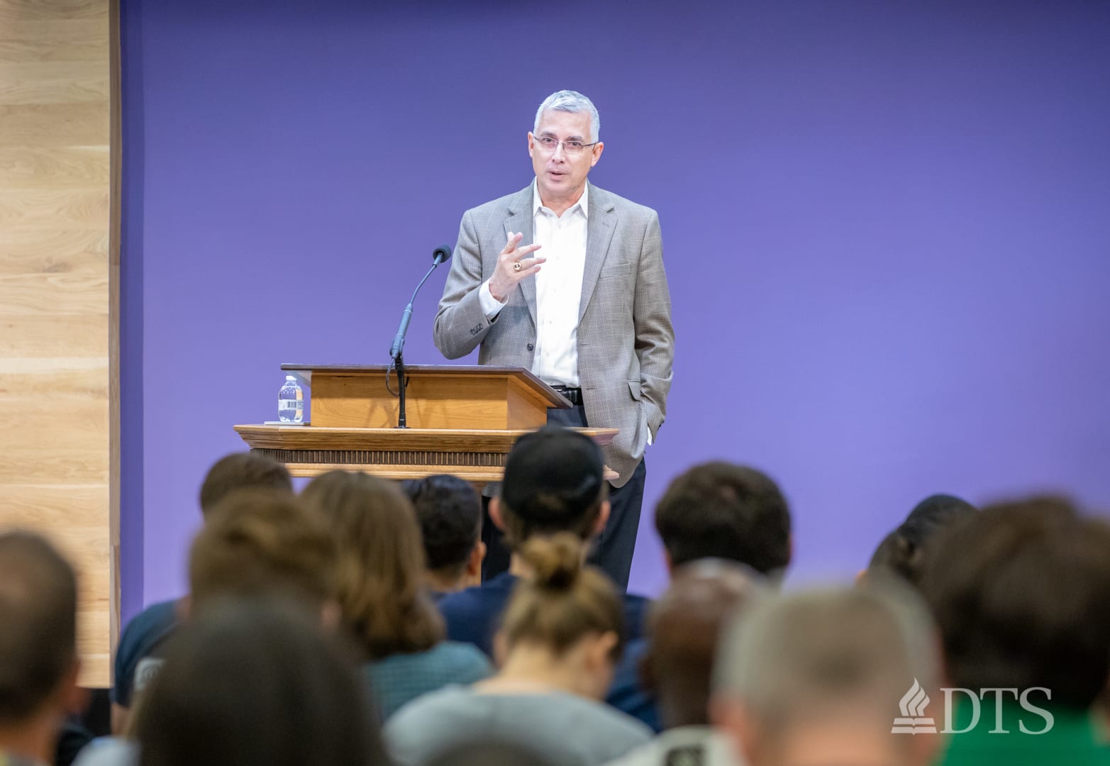 man standing at podium speaking at DTS Chapel