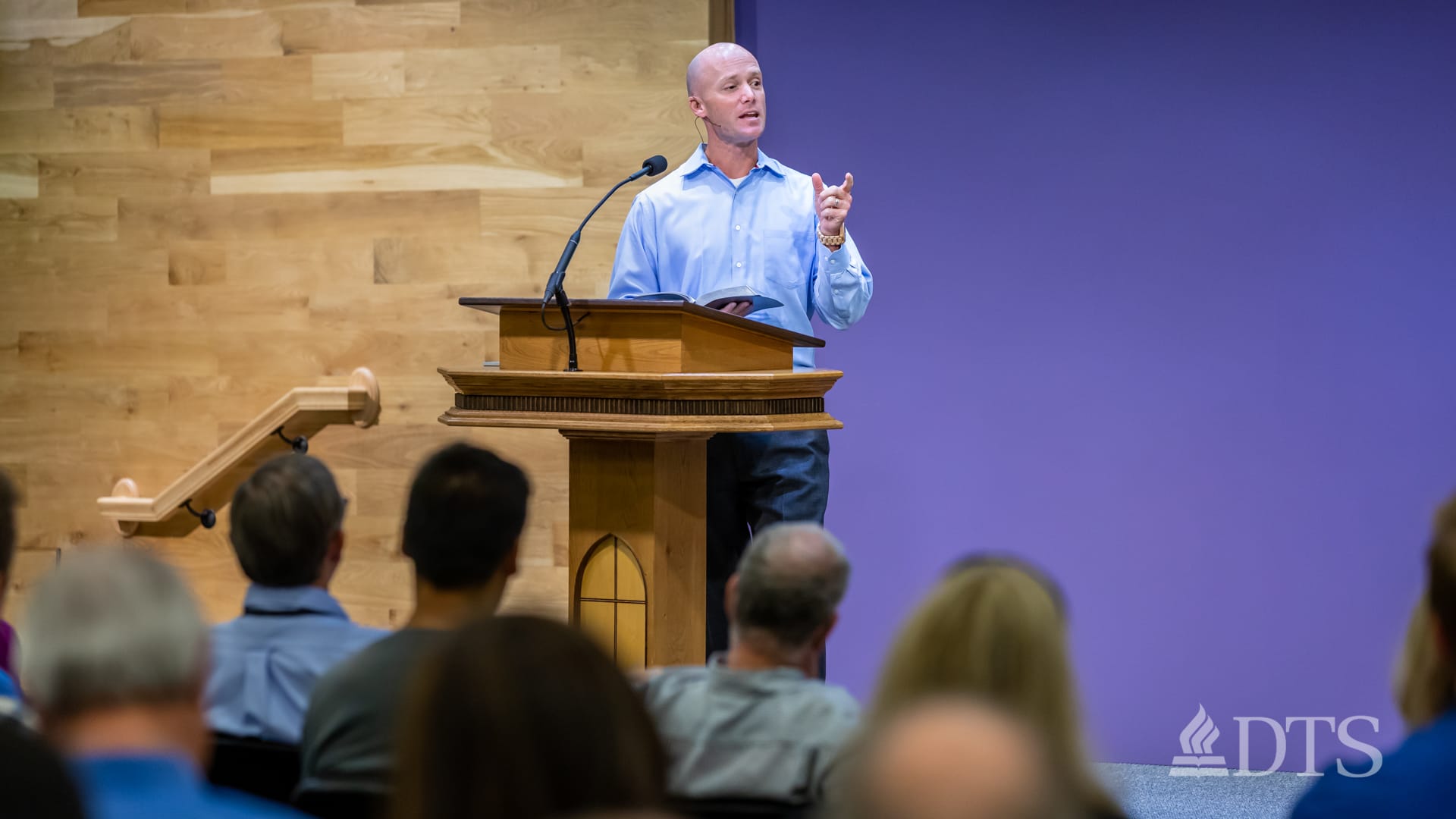 man standing at podium speaking at DTS Chapel