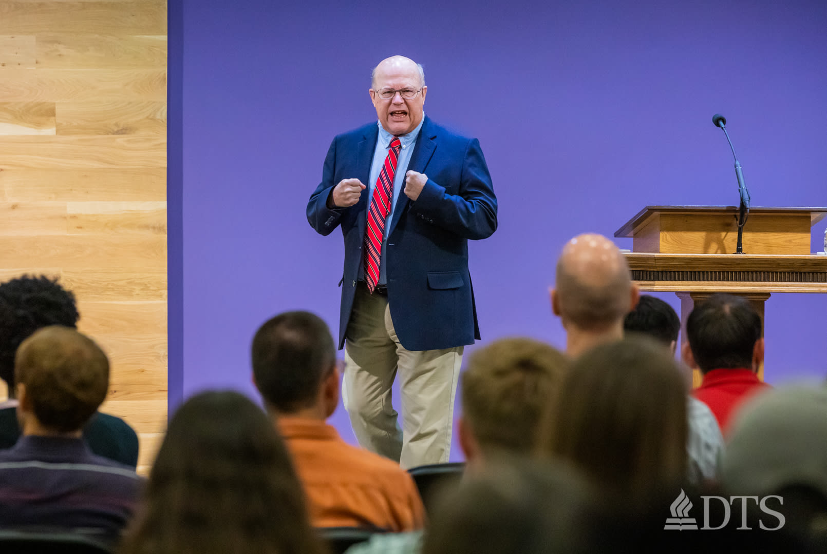 man standing next to podium speaking at DTS Chapel