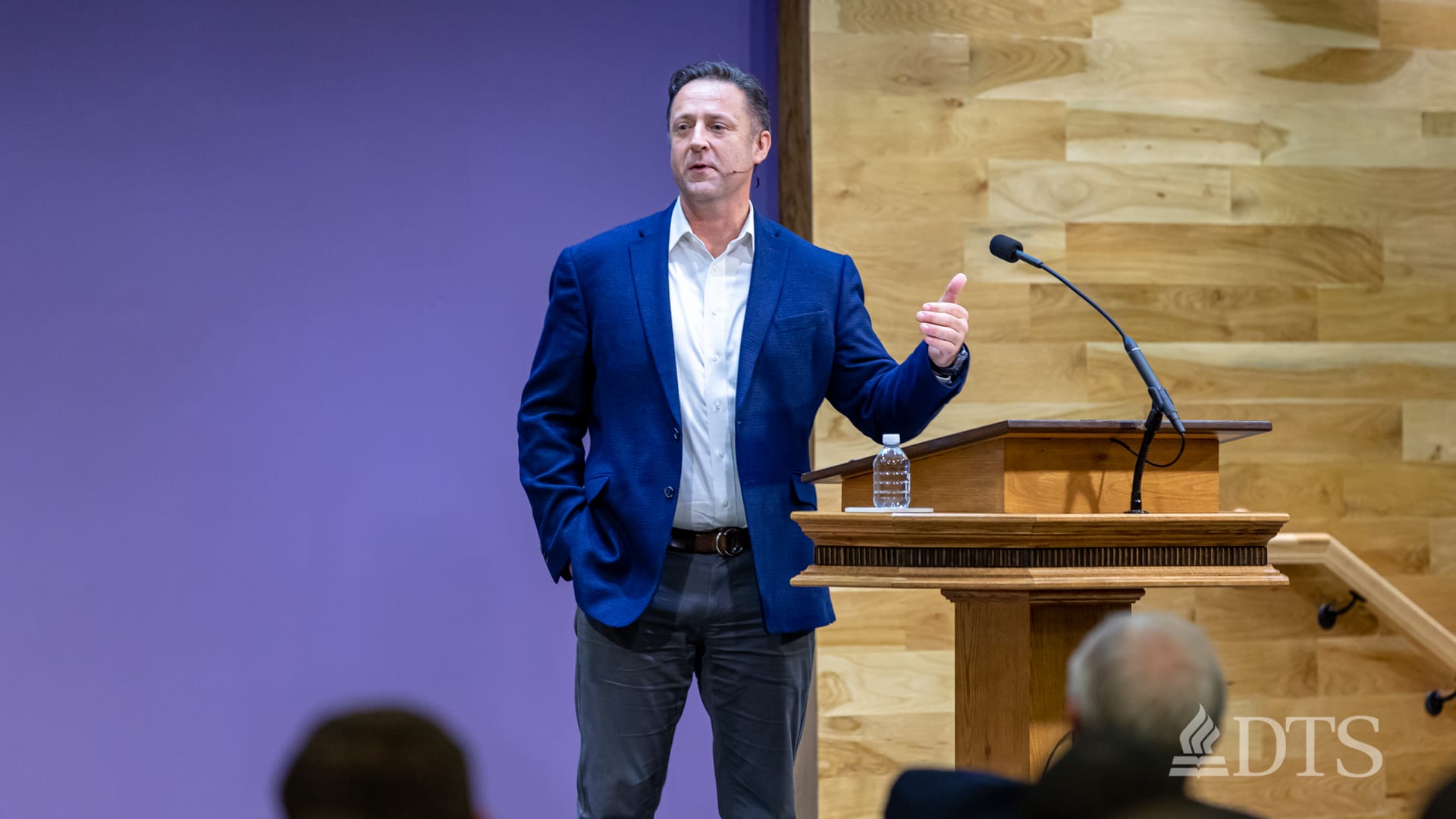 man standing next to podium speaking at DTS Chapel