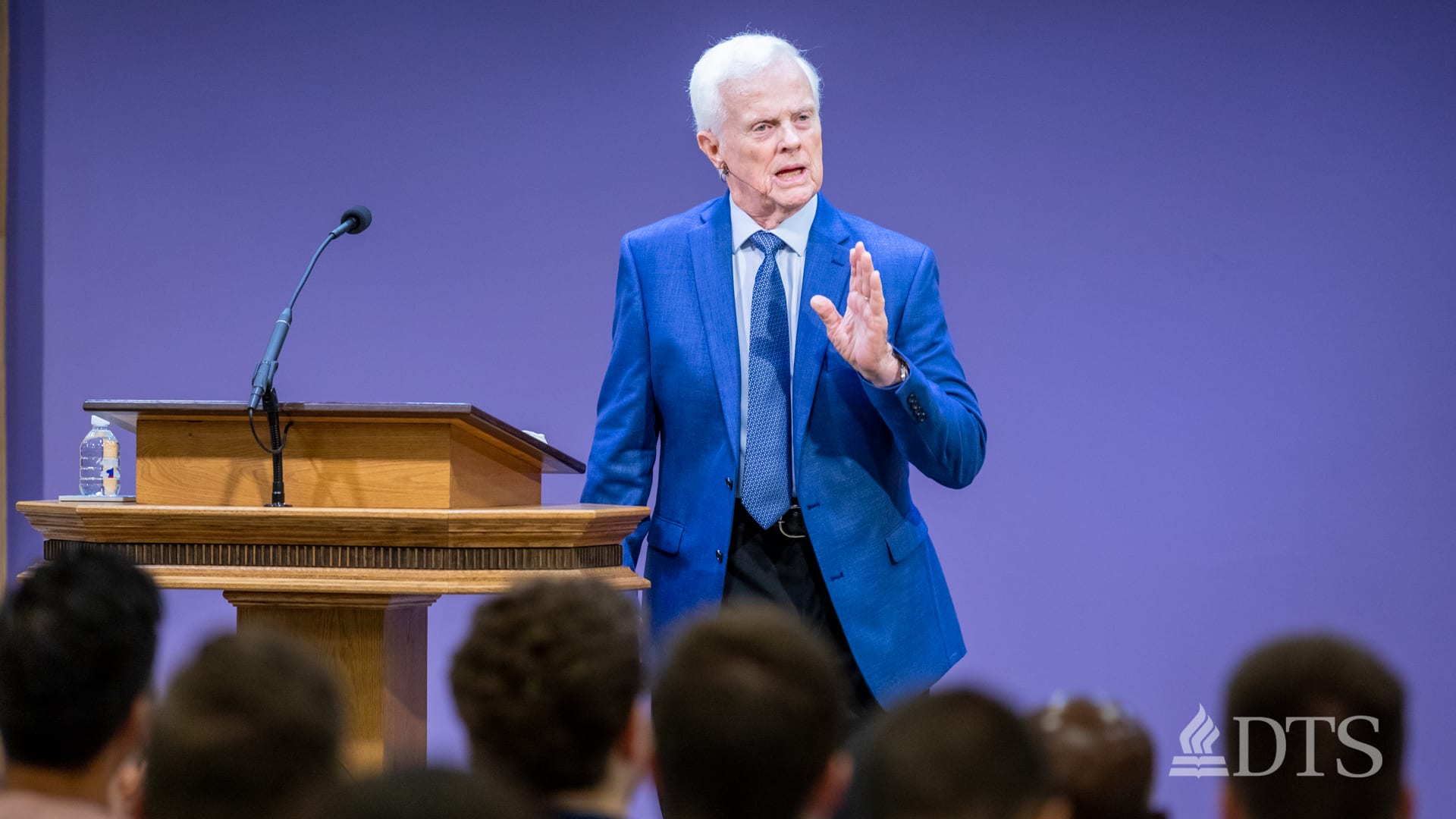 man standing next to podium speaking at DTS Chapel