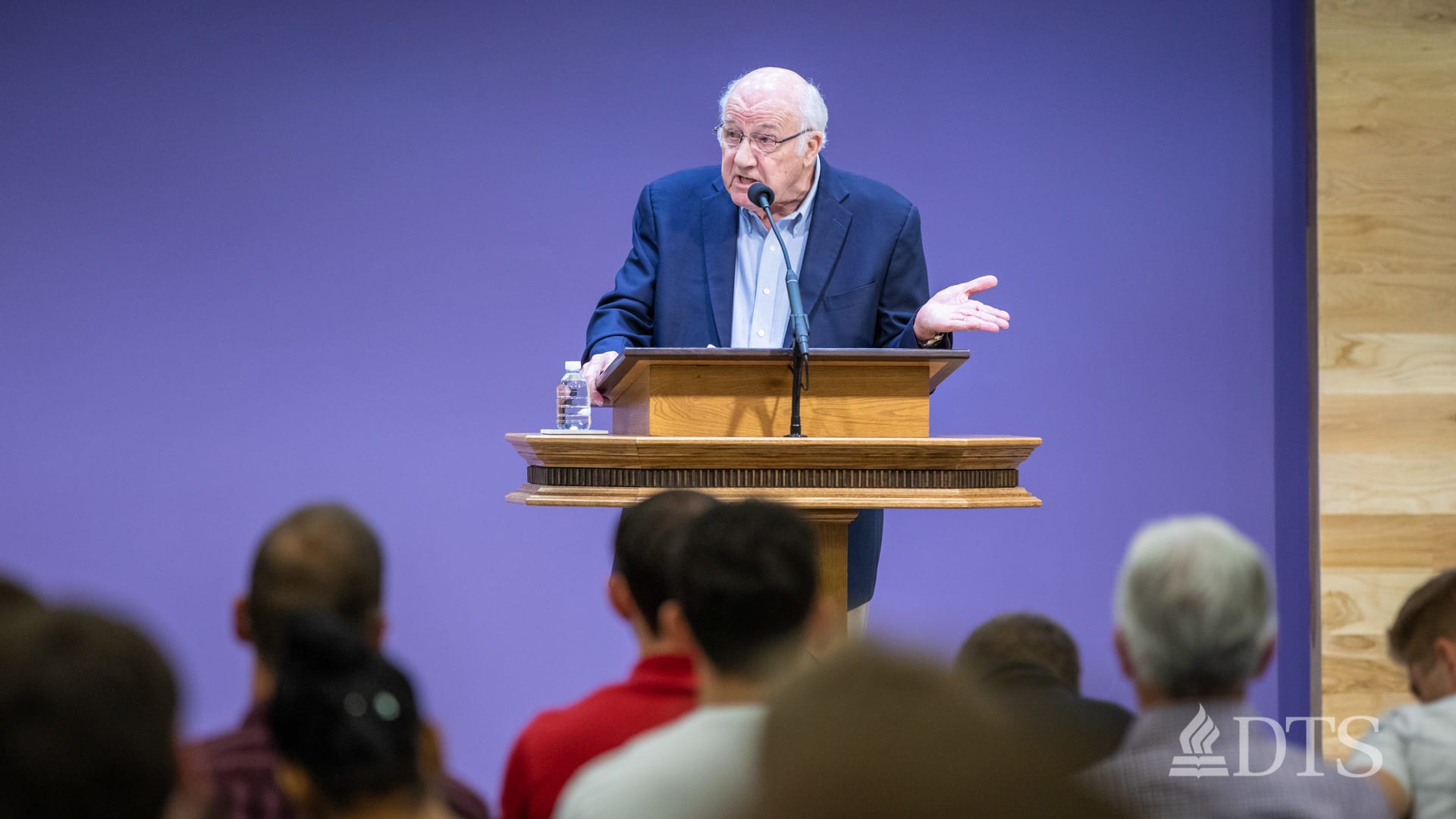 man standing at podium speaking at DTS Chapel