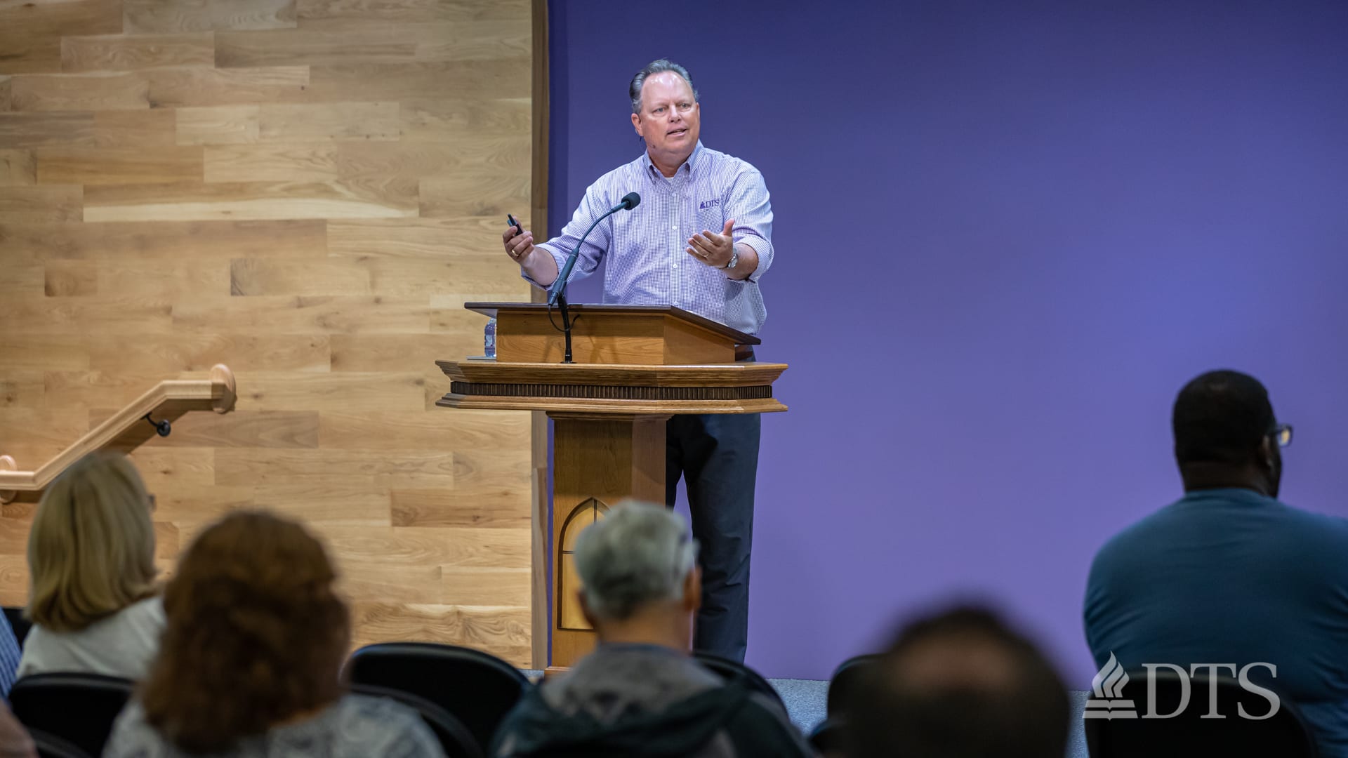man standing at podium speaking at DTS Chapel