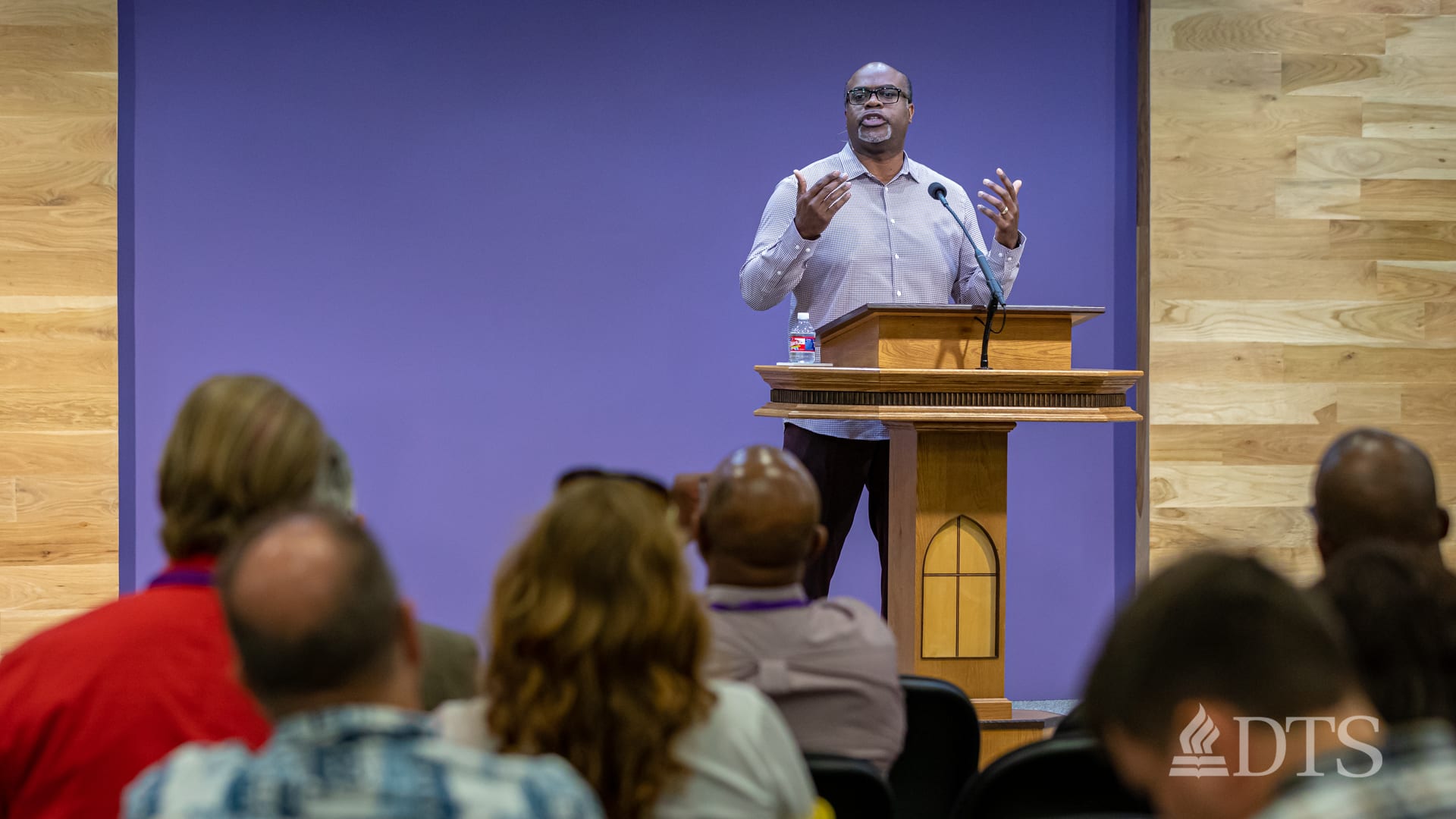 man standing at podium speaking at DTS Chapel