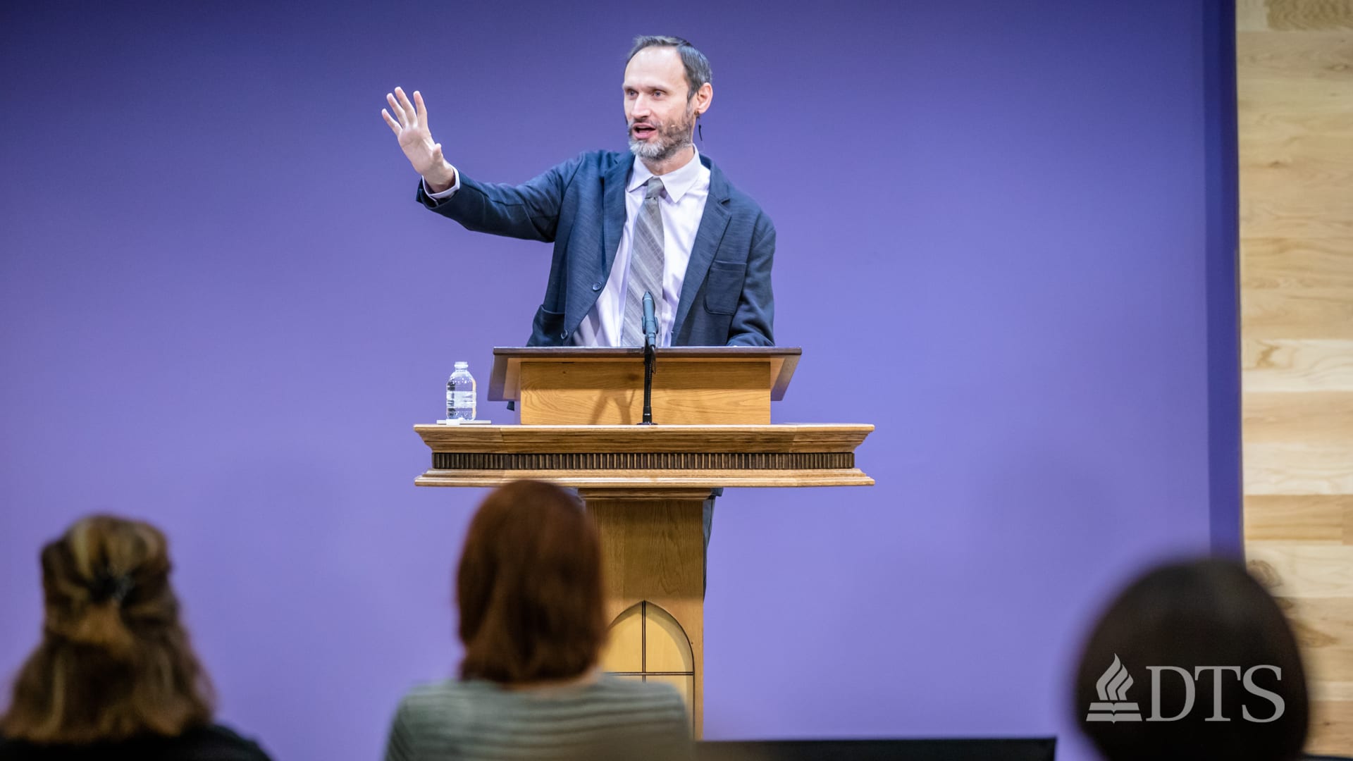 man standing at podium speaking at DTS Chapel