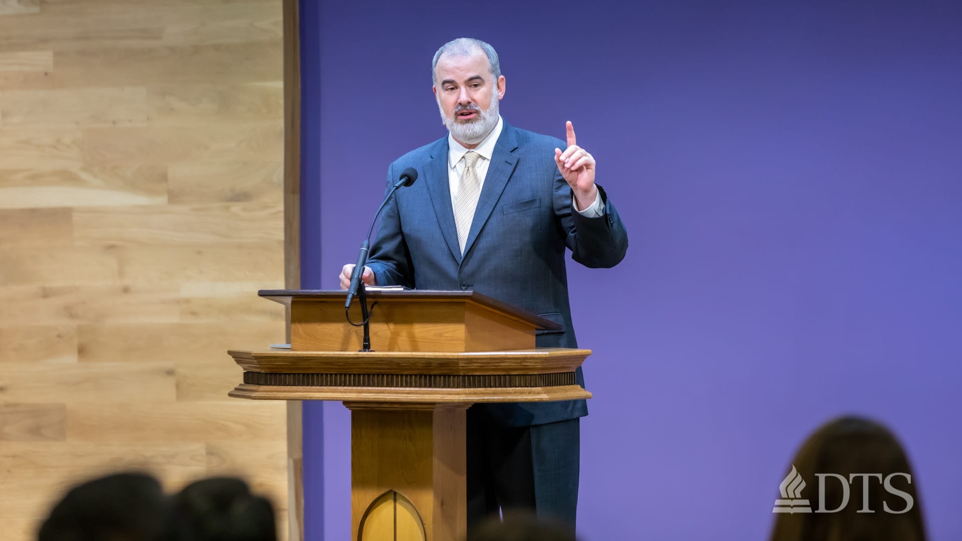 man standing at podium speaking at DTS Chapel