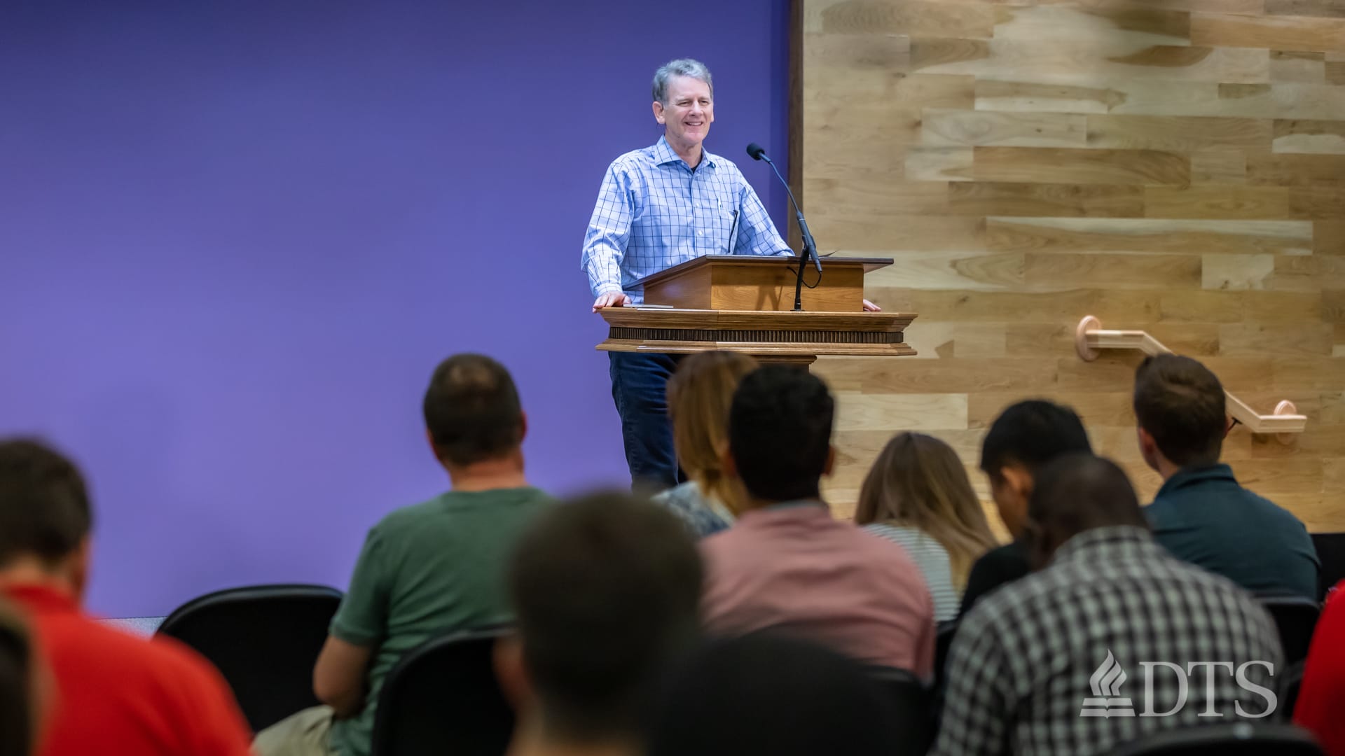 man standing at podium speaking at DTS Chapel