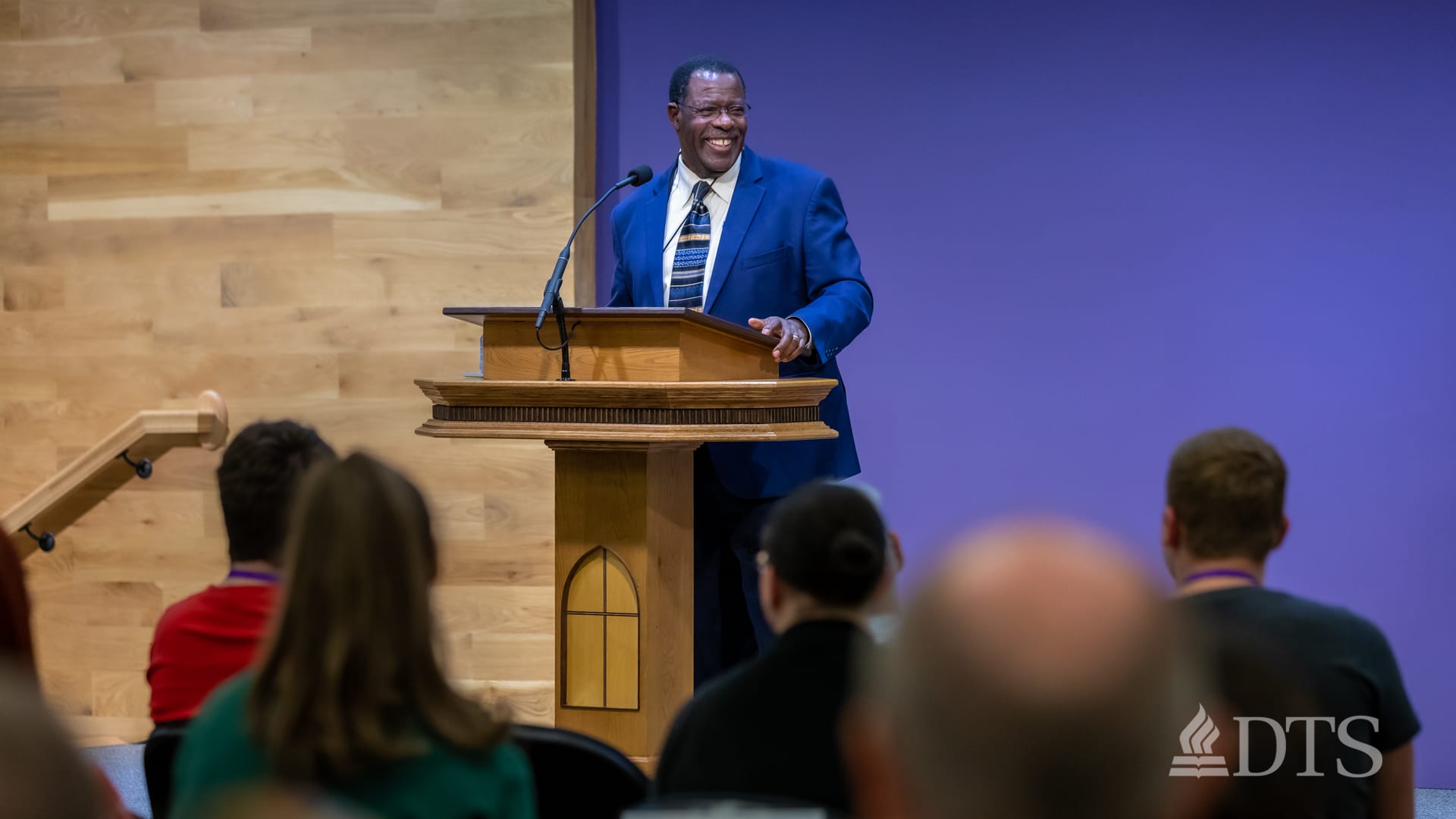 man standing at podium speaking at DTS Chapel