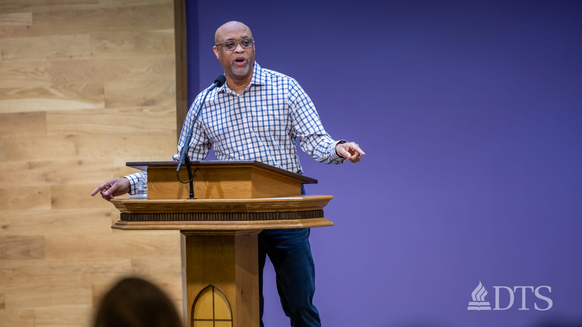 man standing at podium speaking at DTS Chapel