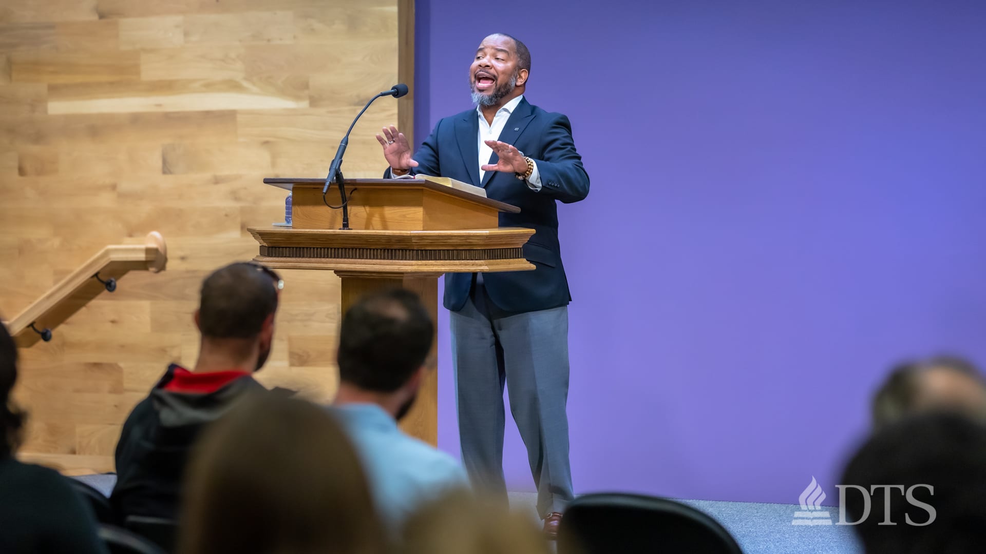 man standing at podium speaking at DTS Chapel