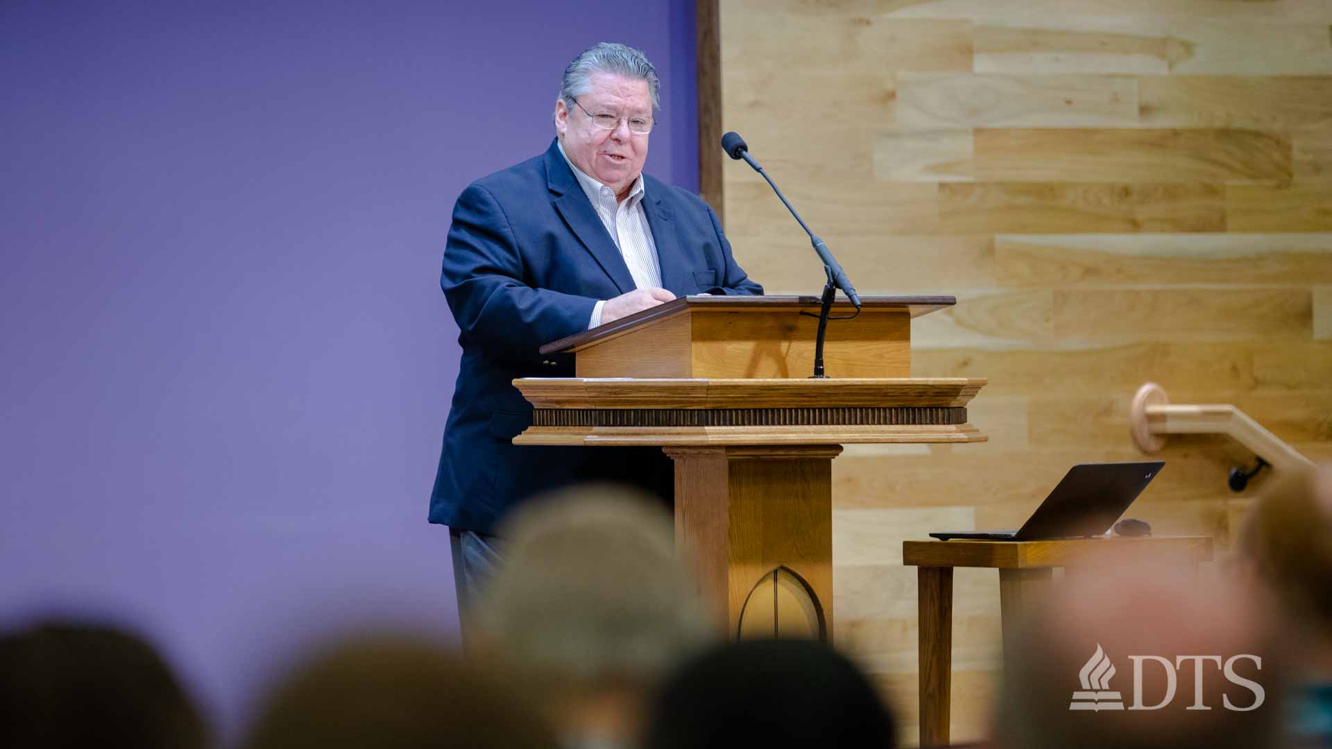 Dr. Mark Bailey standing at podium speaking at DTS Chapel