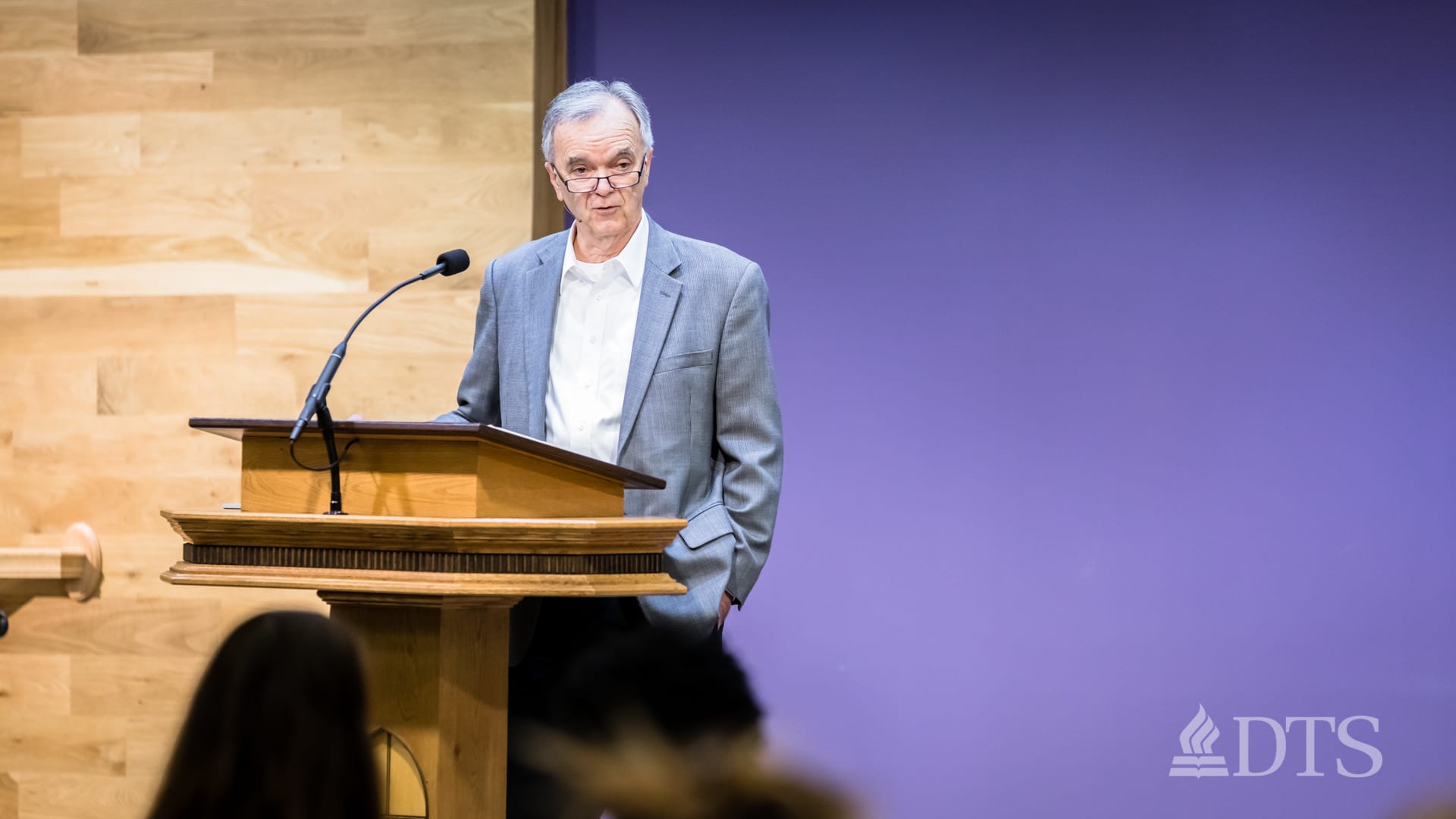 man standing at podium speaking at DTS Chapel