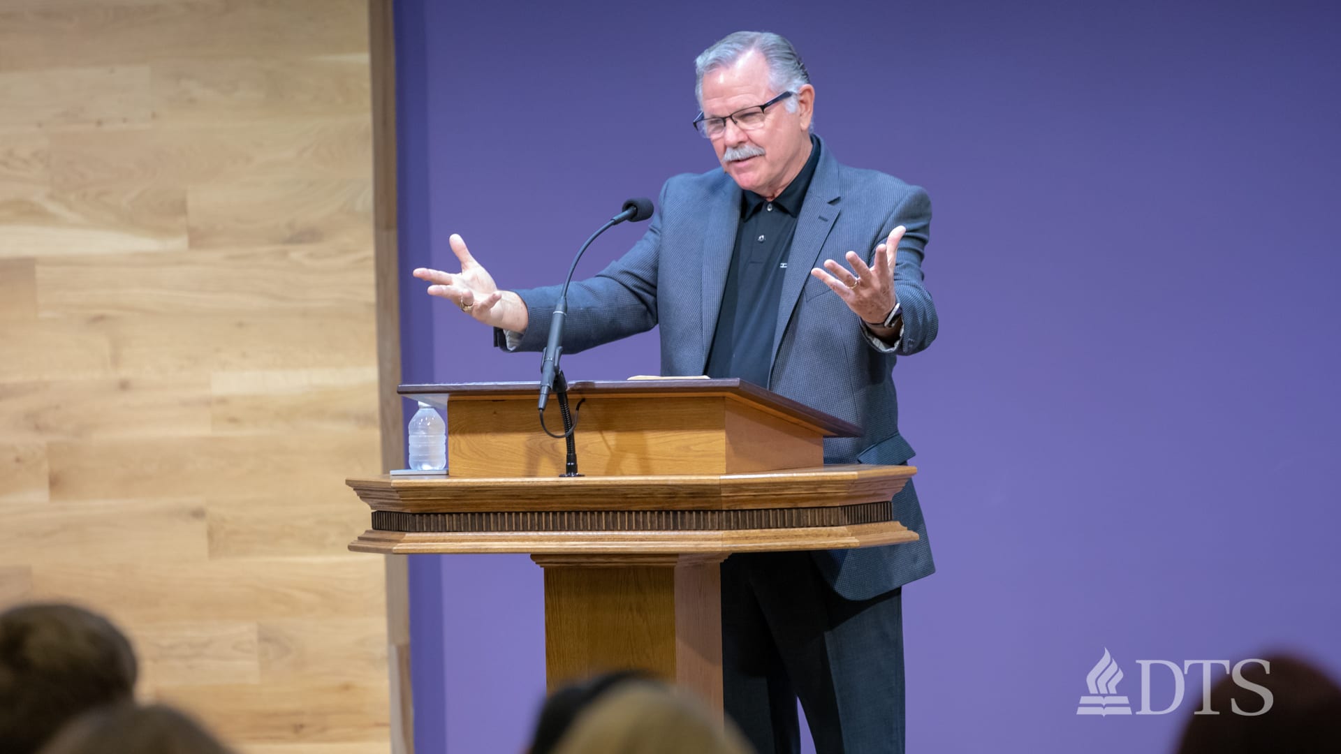 man standing at podium speaking at DTS Chapel