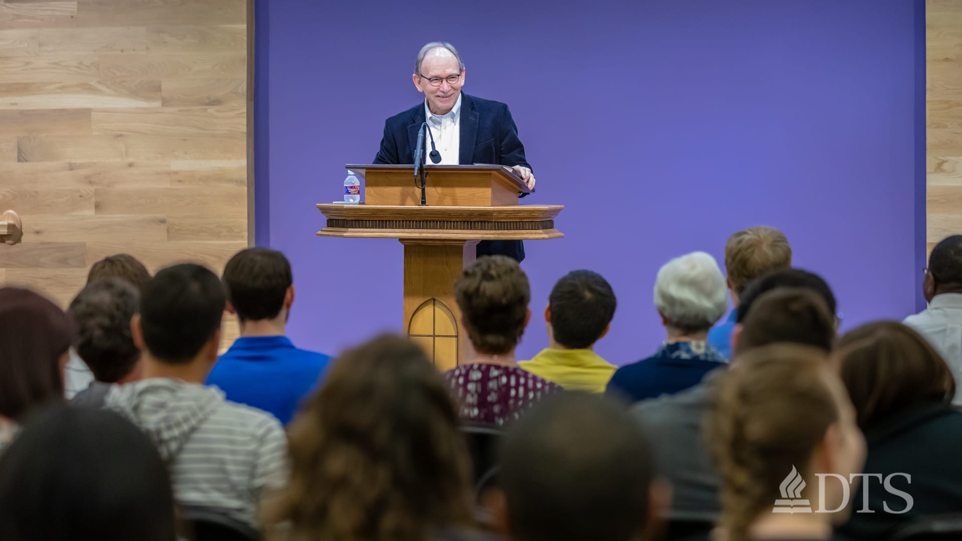 Dr. Scott Horrell standing at podium speaking at DTS Chapel