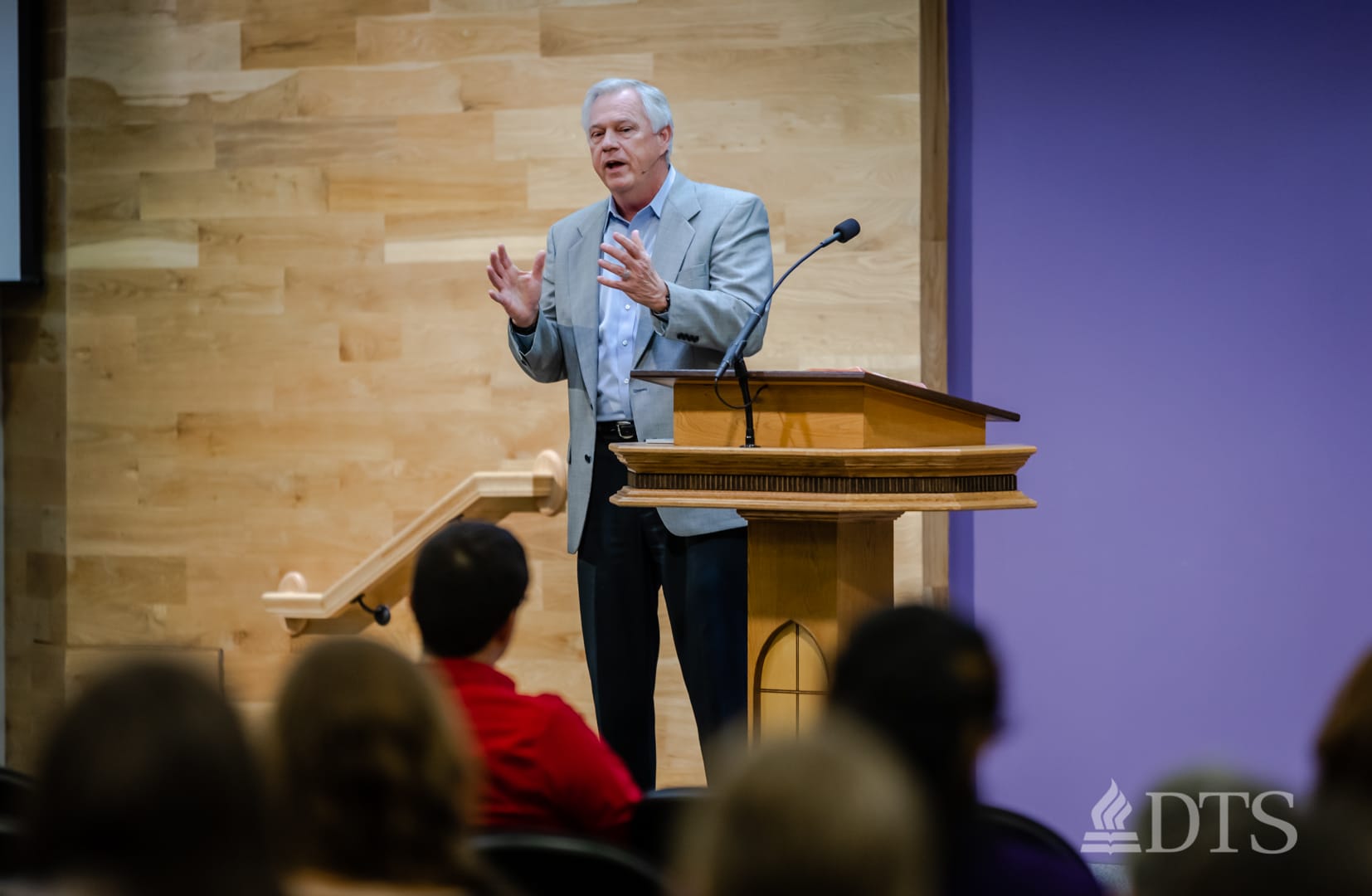 man standing next to podium speaking at DTS Chapel