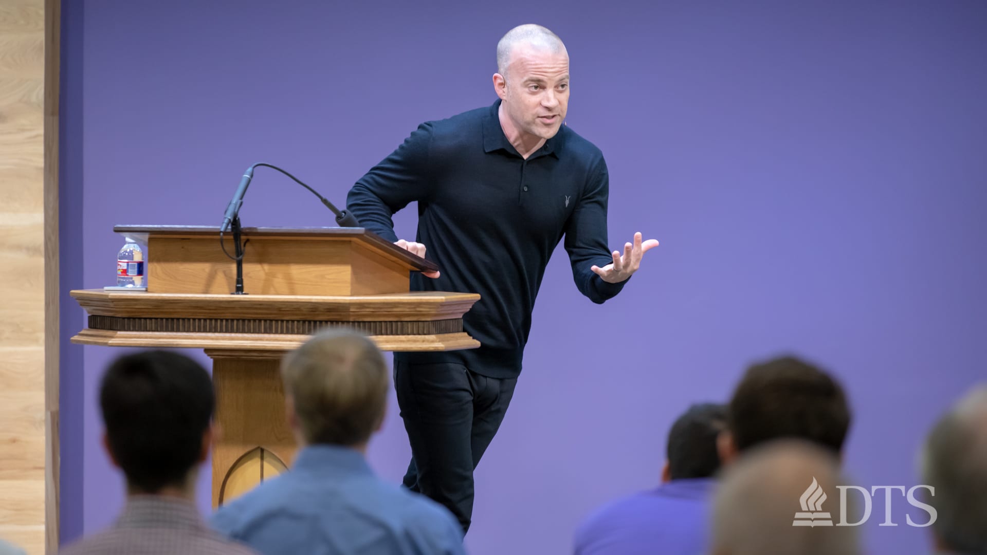 man standing at podium speaking at DTS Chapel