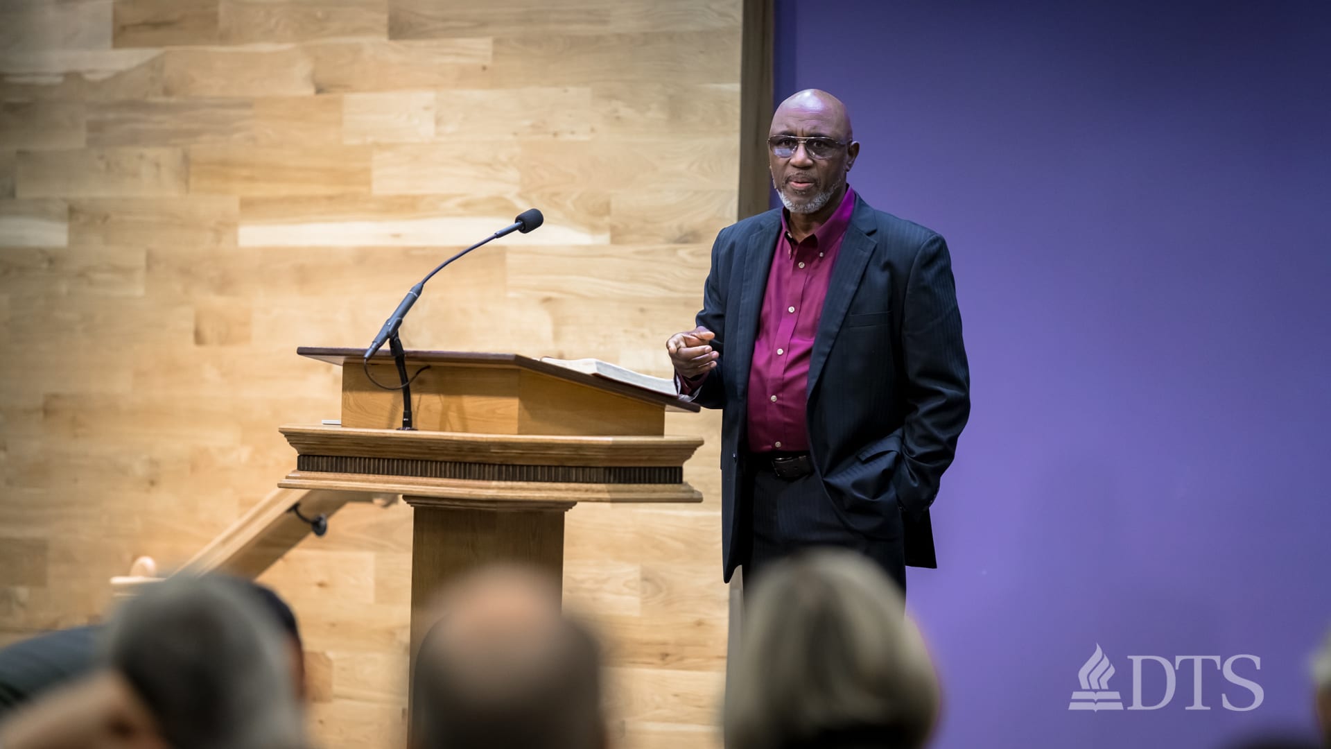 man standing next to podium speaking at DTS Chapel