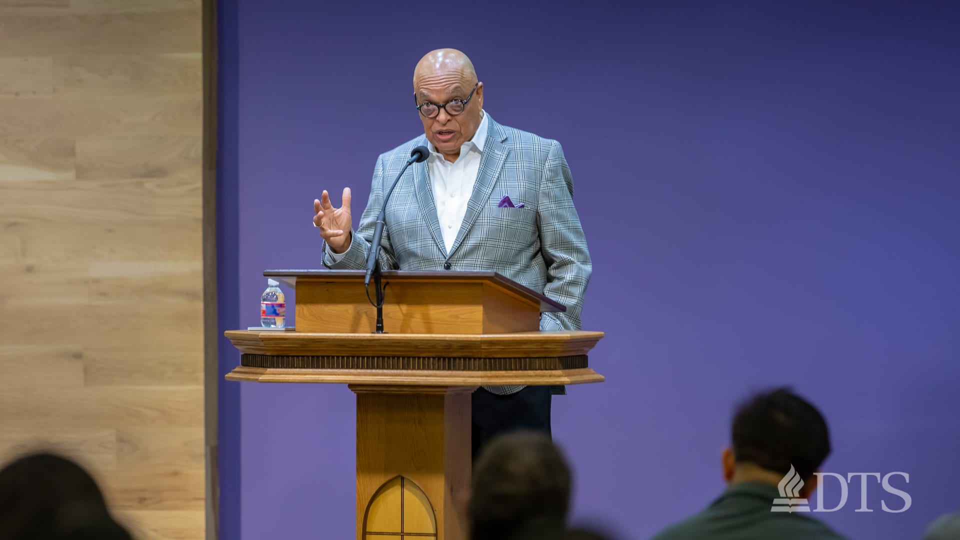 man standing at podium speaking at DTS Chapel