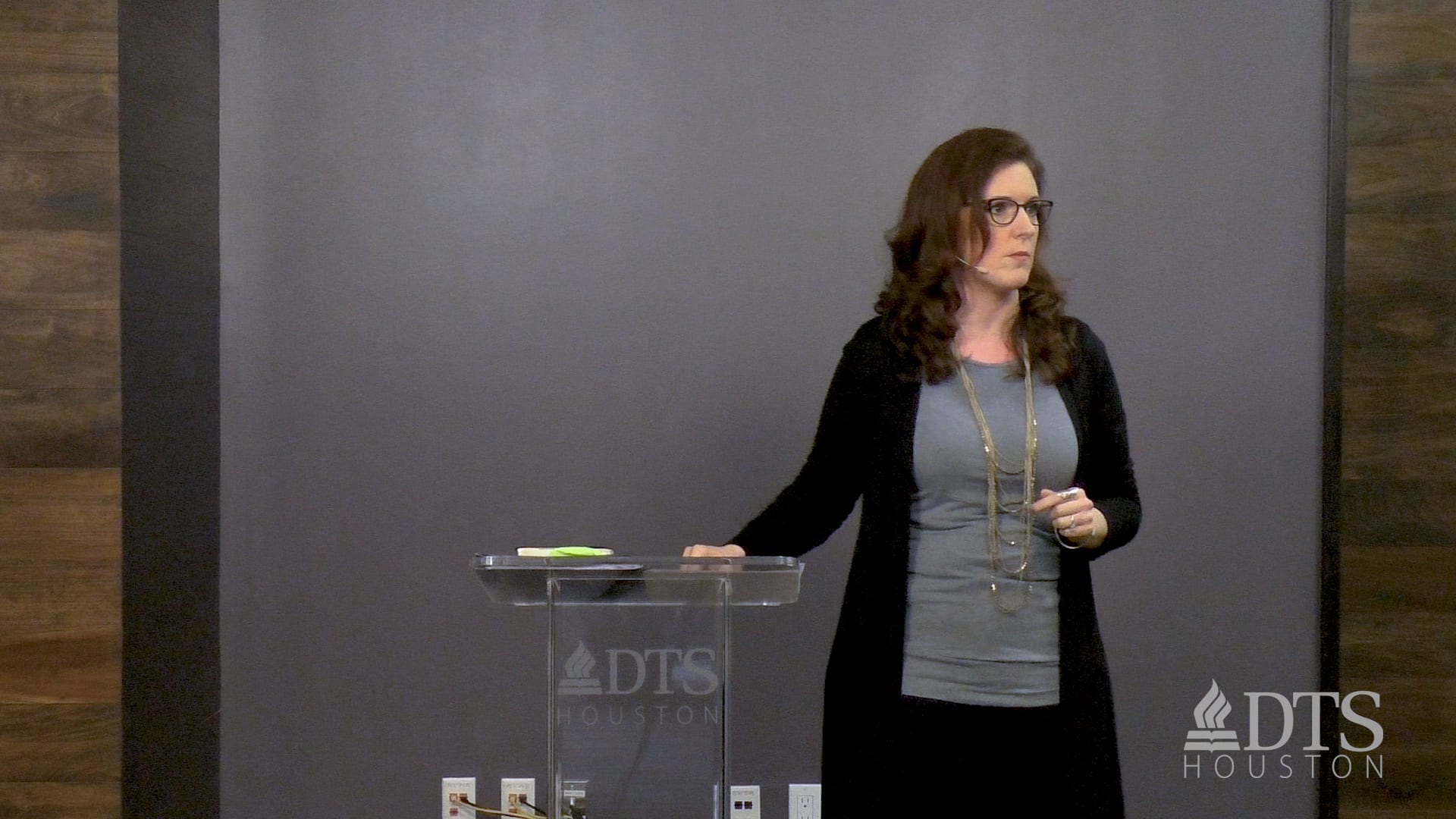 woman standing next to podium speaking at DTS Chapel