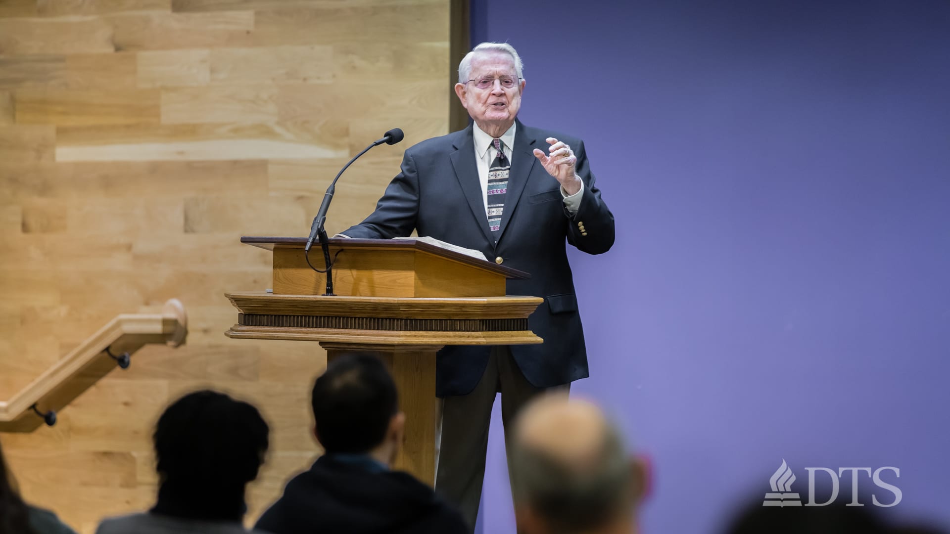Dr. Chuck Swindoll standing at podium speaking at DTS Chapel