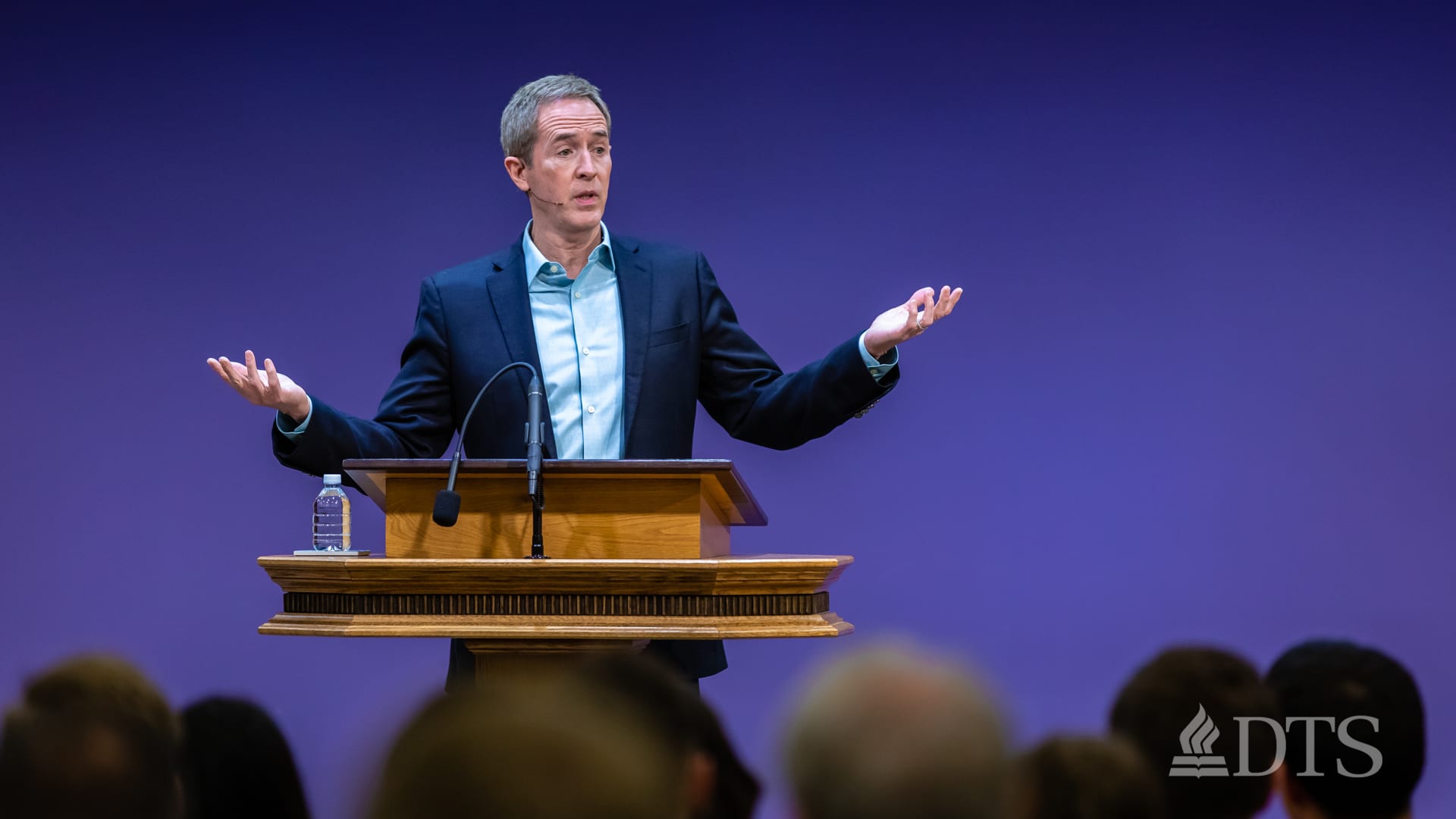 man standing at podium speaking at DTS Chapel