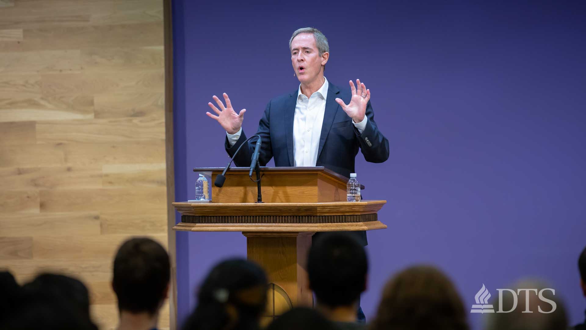 man standing at podium speaking at DTS Chapel